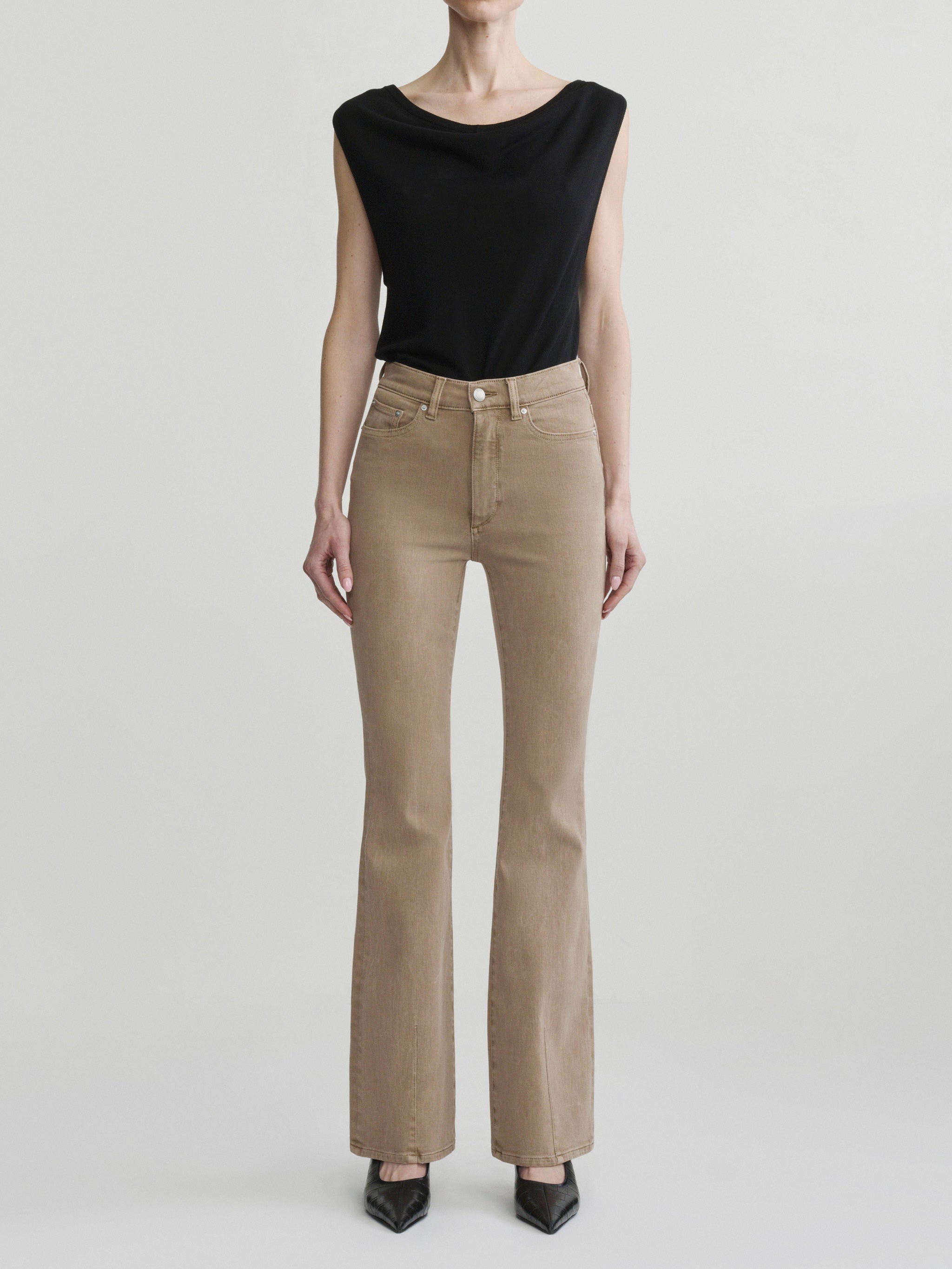 Bridget Boot jeans in Desert styled with the Defined Flow Top in Black, full-length front view, studio.