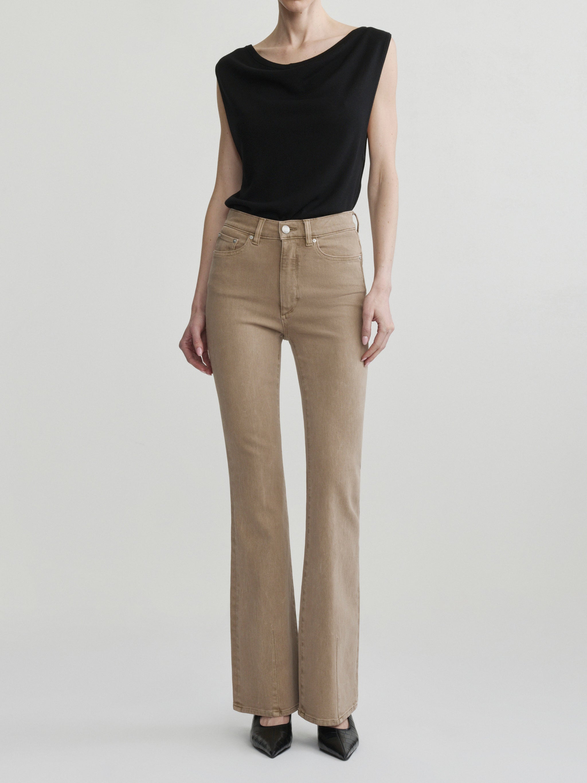 Bridget Boot jeans in Desert with the Defined Flow Top in Black, full-length front view in a studio.