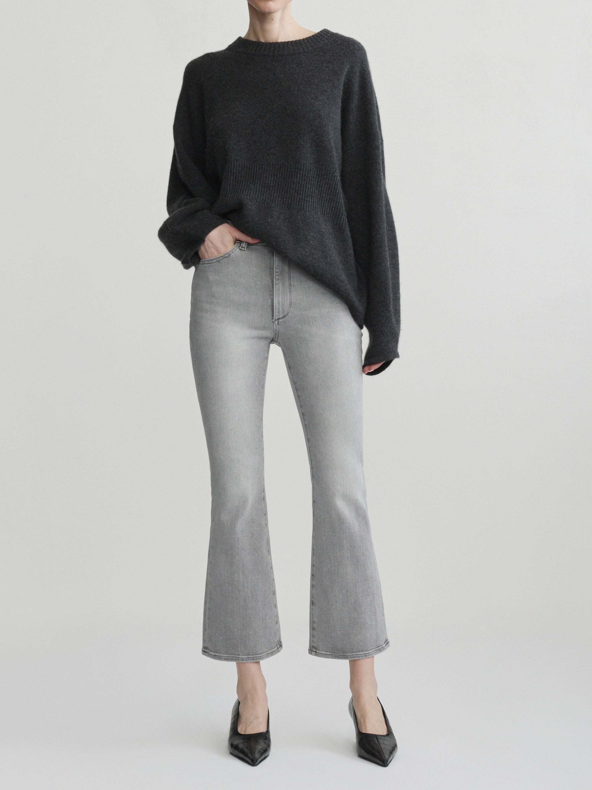 Bridget Boot jeans in Light Smoke on a model with a charcoal sweater, full-length front view, studio.