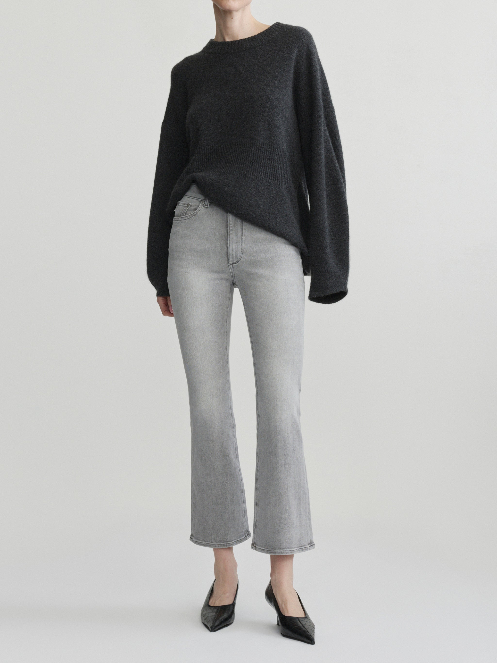 Bridget Boot jeans in Light Smoke on a model with a charcoal sweater, full-length front view, studio.