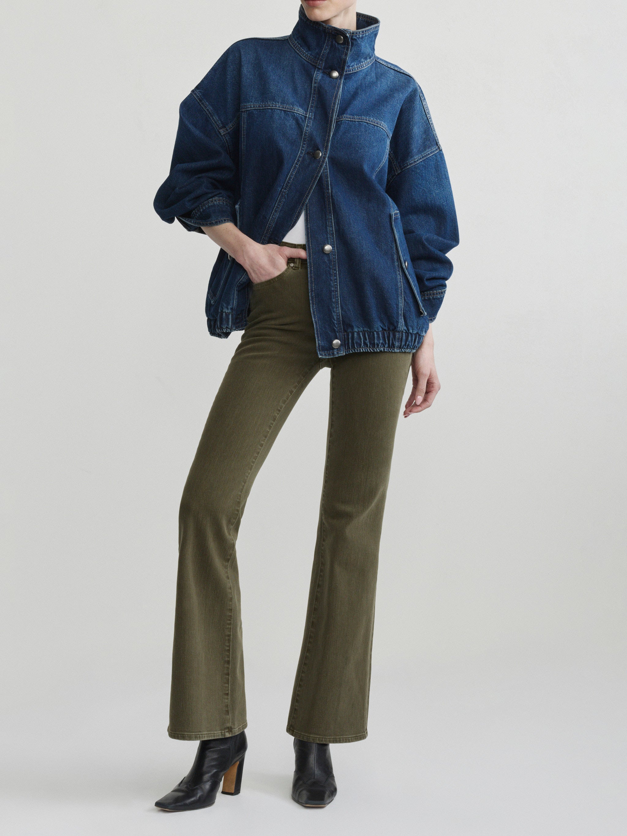 Bridget Boot jeans in Pine styled with the Nara Jacket in December, full-length front view in a studio.