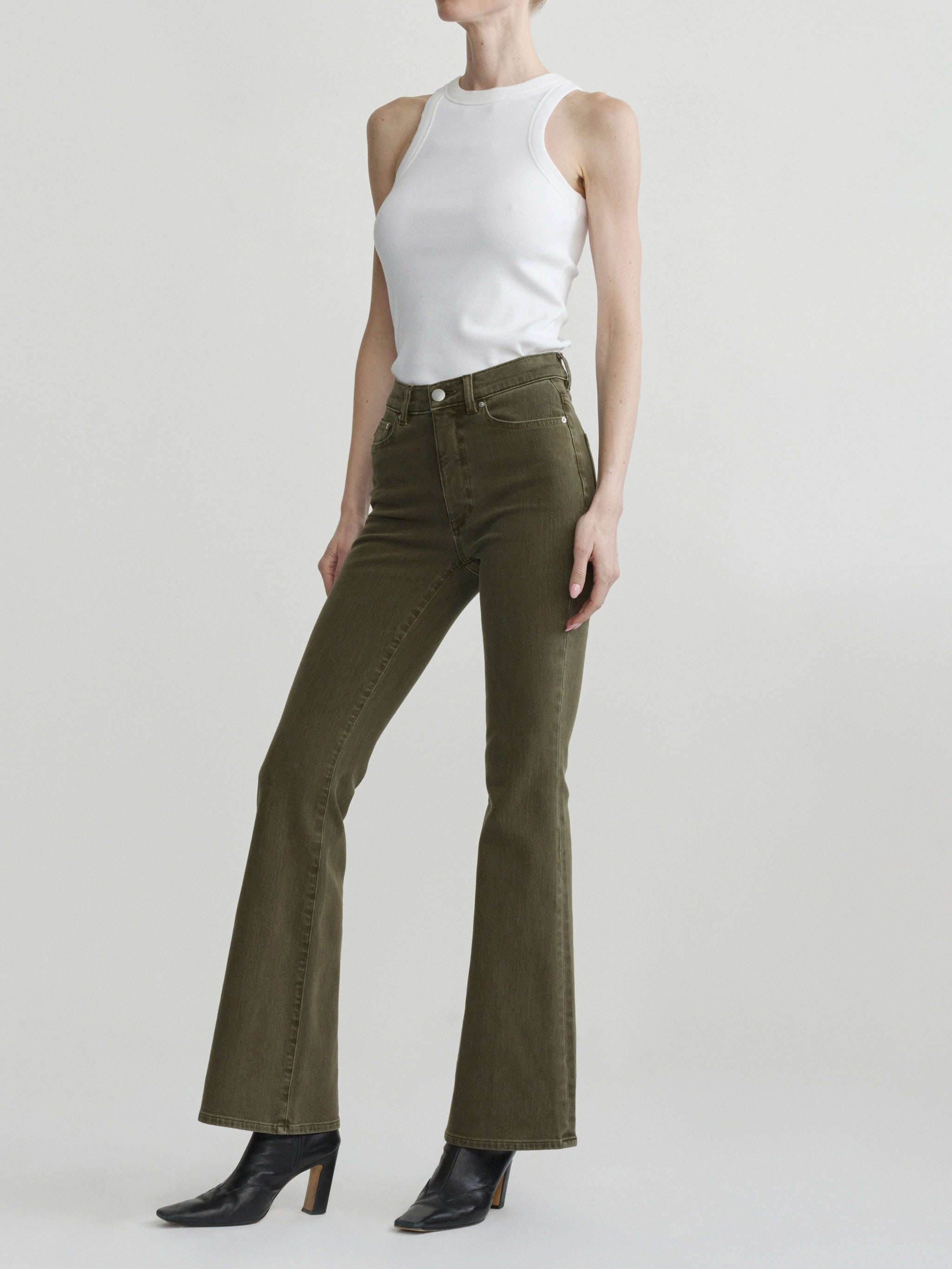 Bridget Boot jeans in Pine on a model with a white tank, full-length front view in a studio.