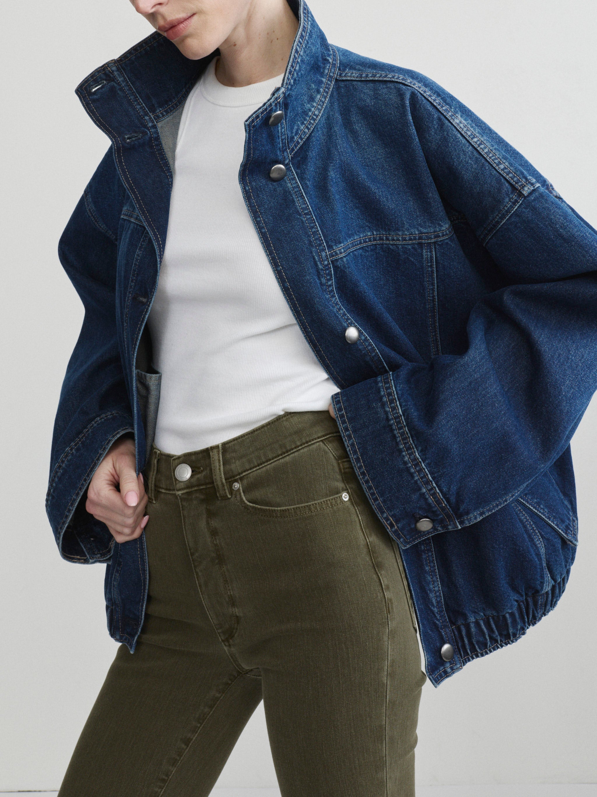 Bridget Boot jeans in Pine with the Nara Jacket in December denim on a model, three-quarter front view in studio.