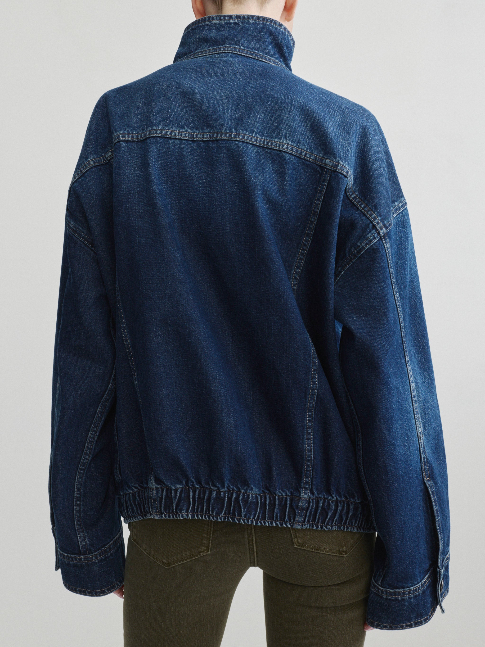 Bridget Boot jeans in Pine with the Nara Jacket in December denim on a model, back view in studio.