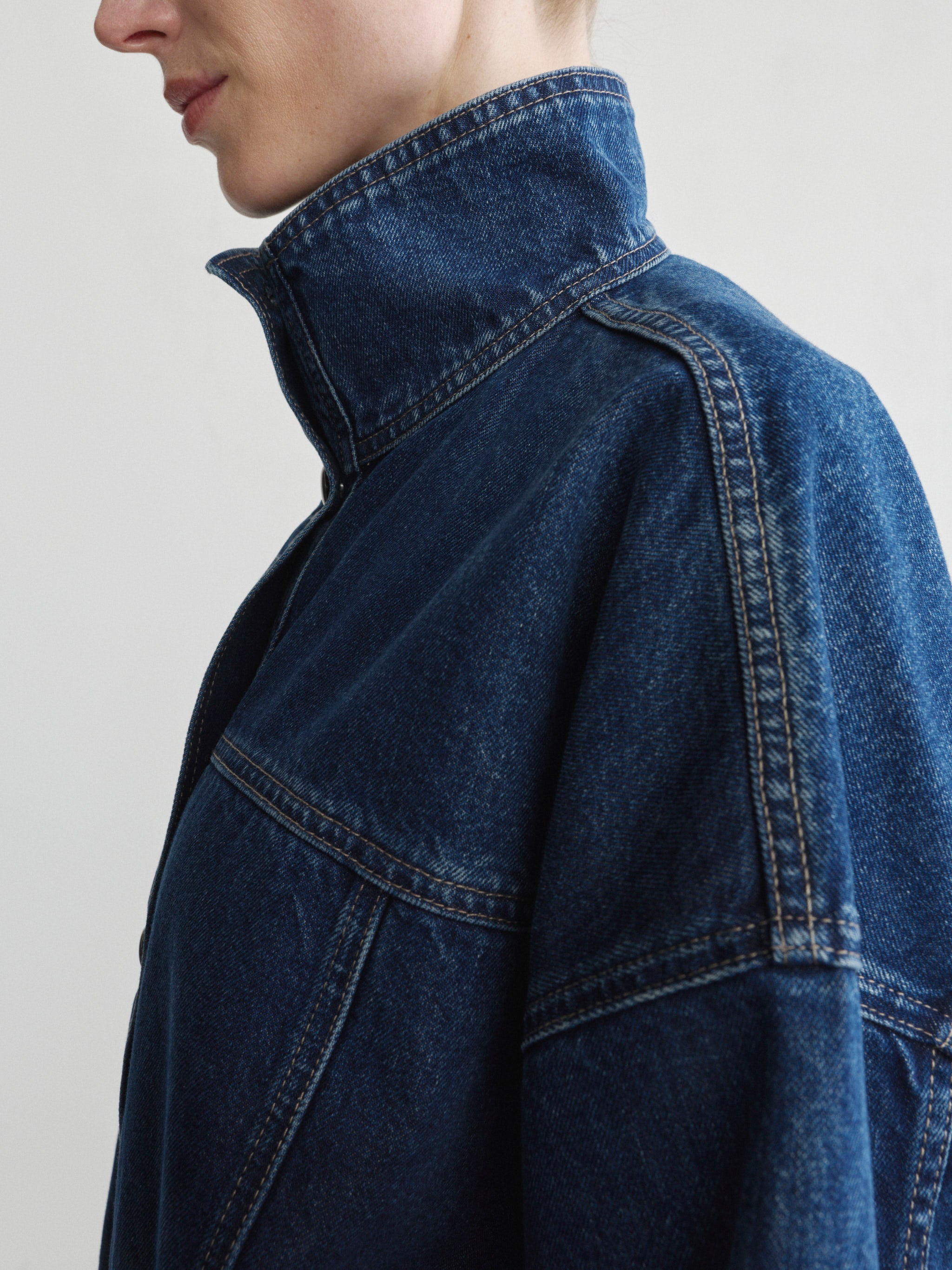 Bridget Boot jeans in Pine with the Nara Jacket in December denim on a model, close-up of collar and shoulder.