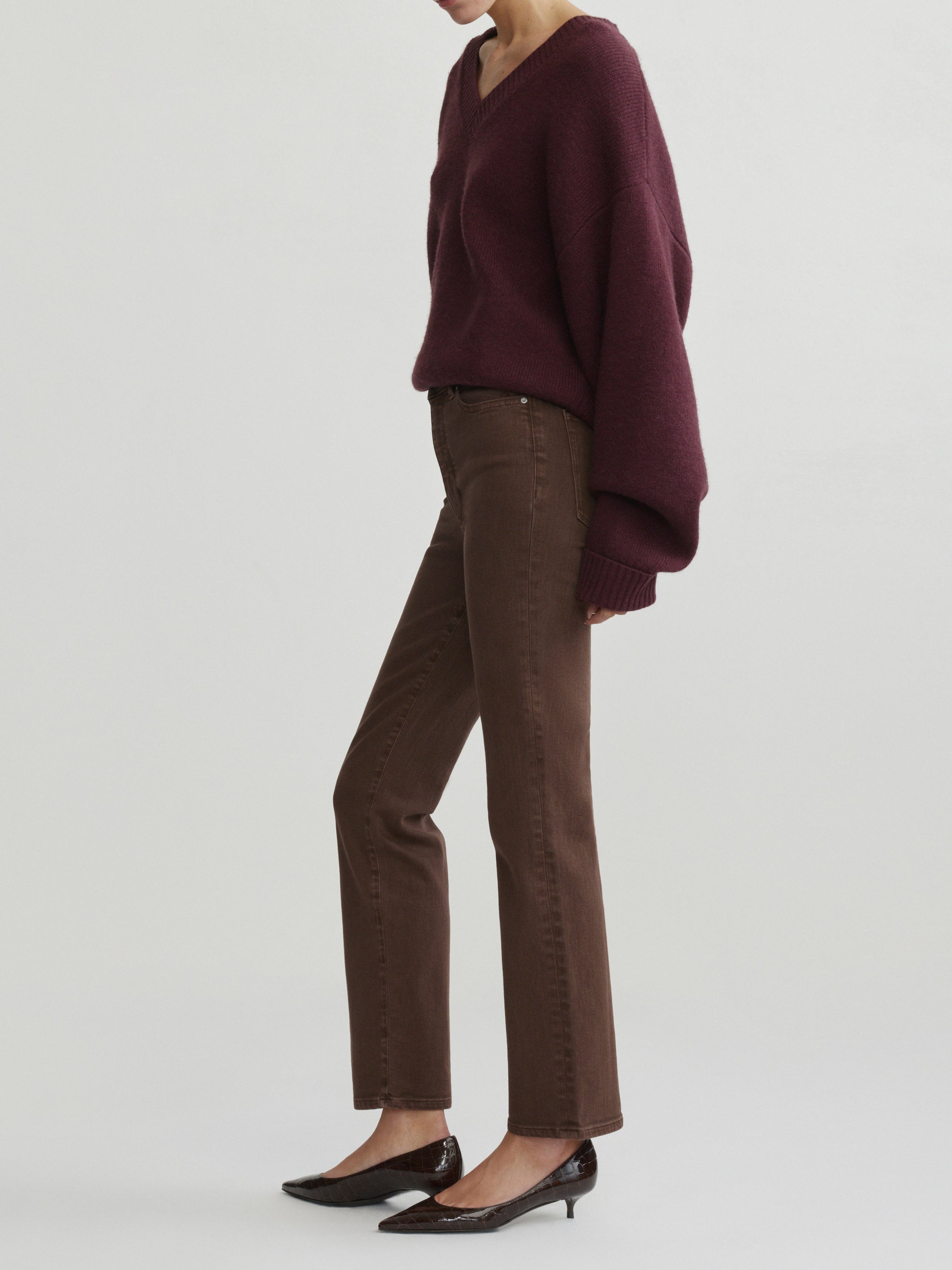 Halle Straight jeans in Brownstone with Robbie Sweater in Cacao on a model, full-length side view in studio.