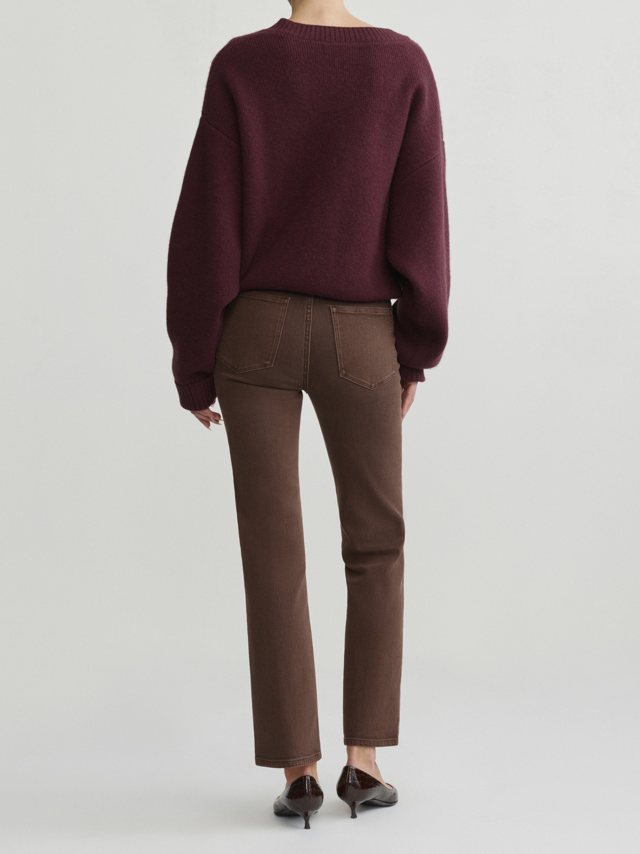 Halle Straight jeans in Brownstone with Robbie Sweater in Cacao on a model, full-length back view in studio.