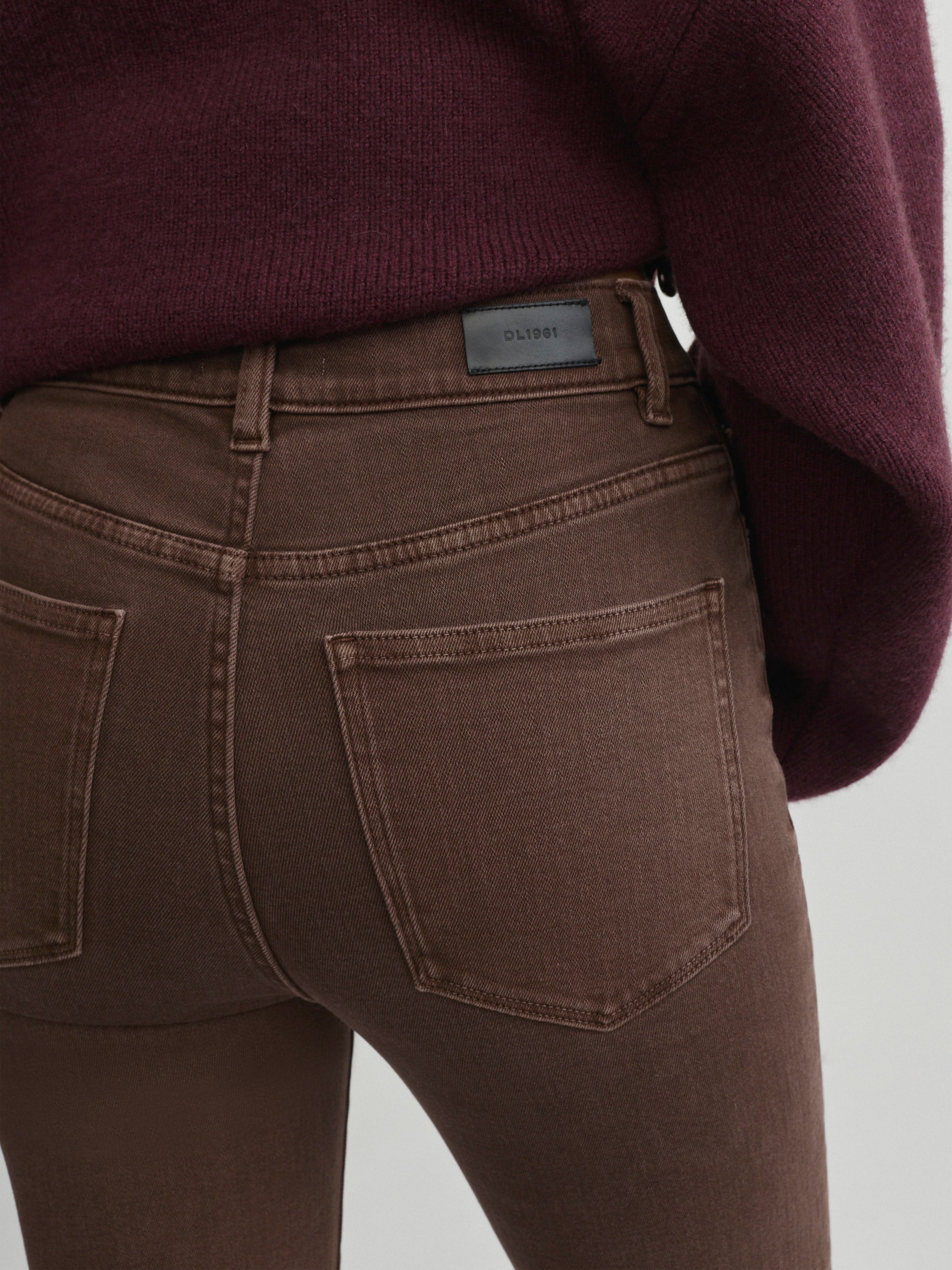 Halle Straight jeans in Brownstone with Robbie Sweater in Cacao on a model, close-up back view of pockets.