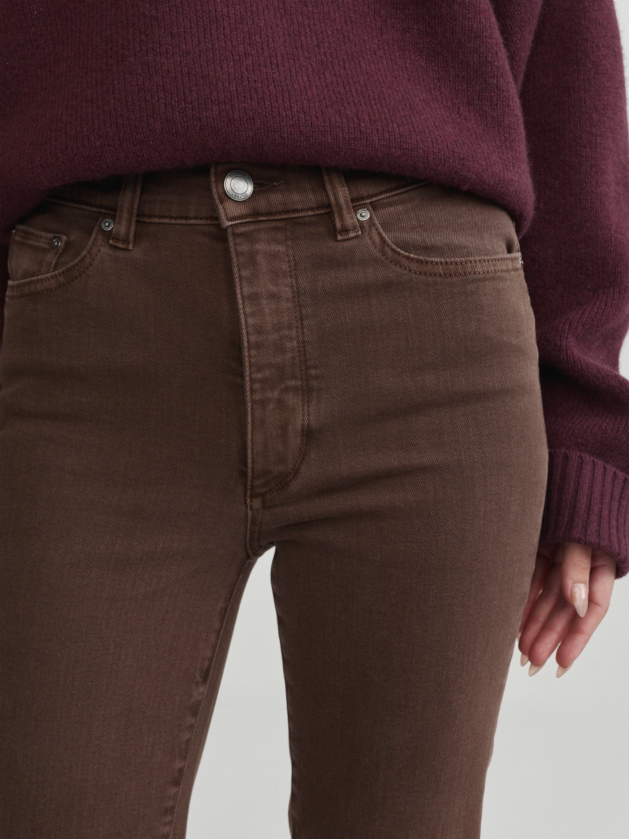 Halle Straight jeans in Brownstone with Robbie Sweater in Cacao on a model, close-up front view of waist.