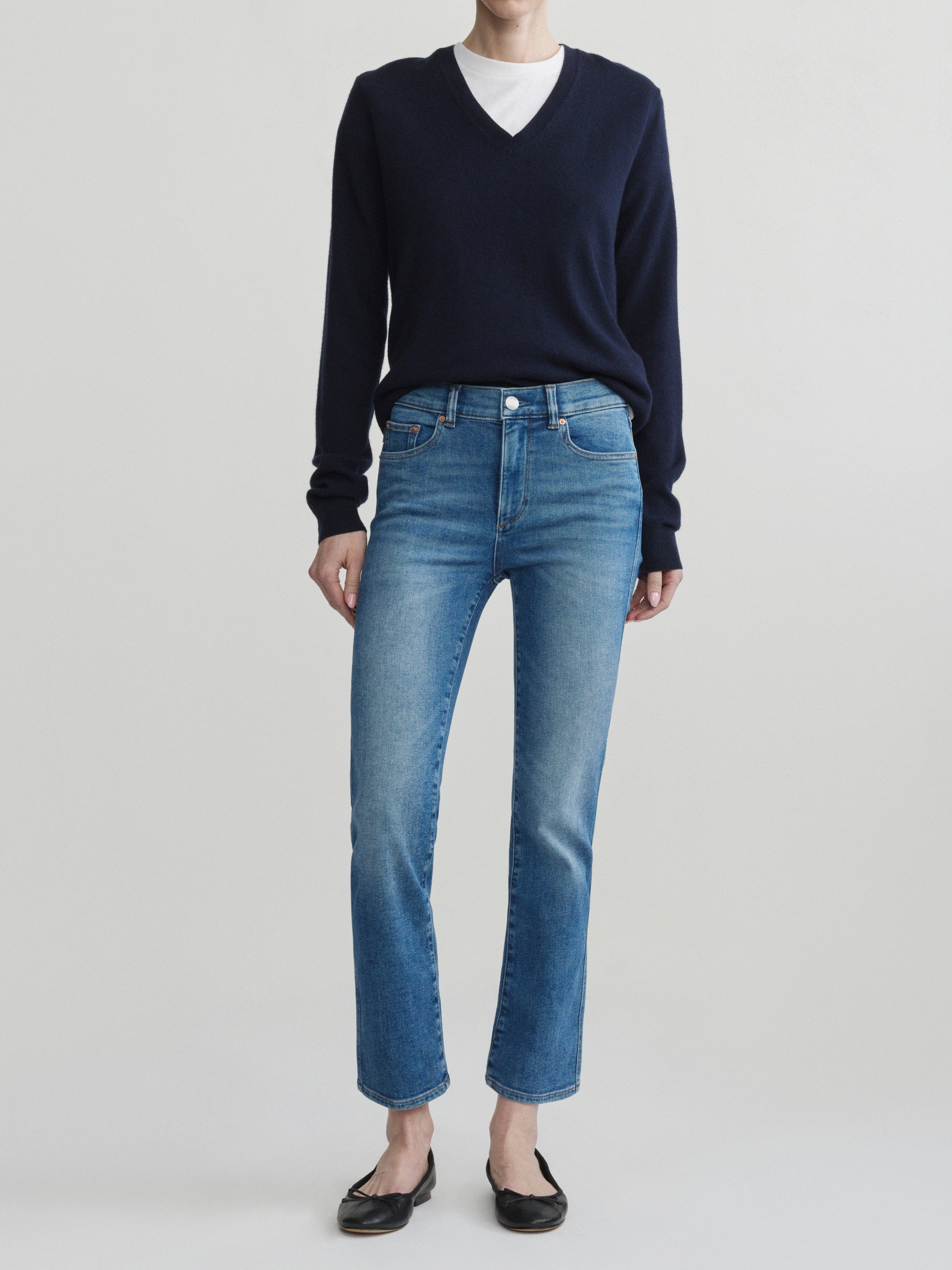 Mara Straight jeans in Crisp Air with a navy sweater on a model, full-length front view in studio.