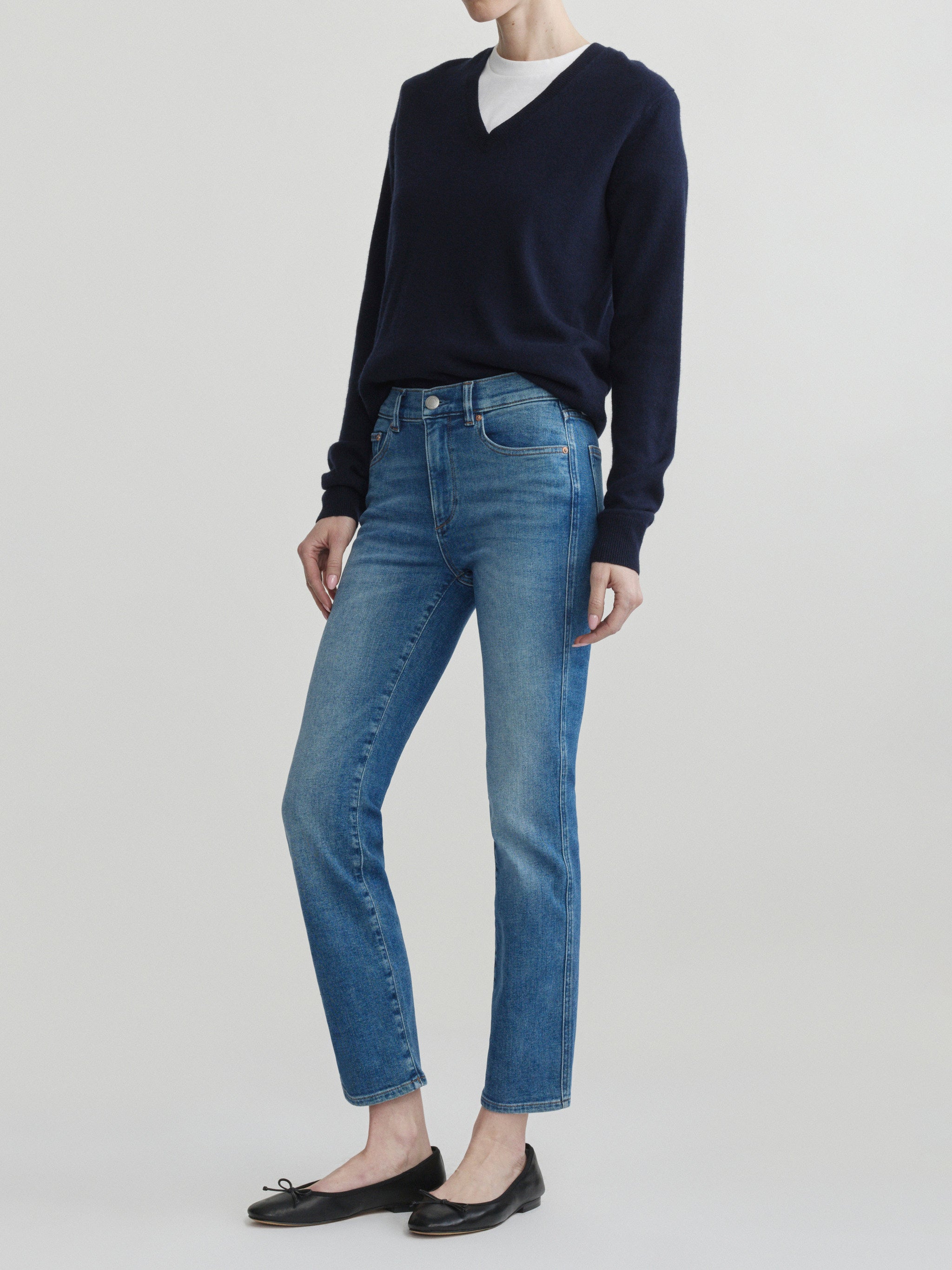Mara Straight jeans in Crisp Air with a navy sweater on a model, full-length three-quarter view in studio.