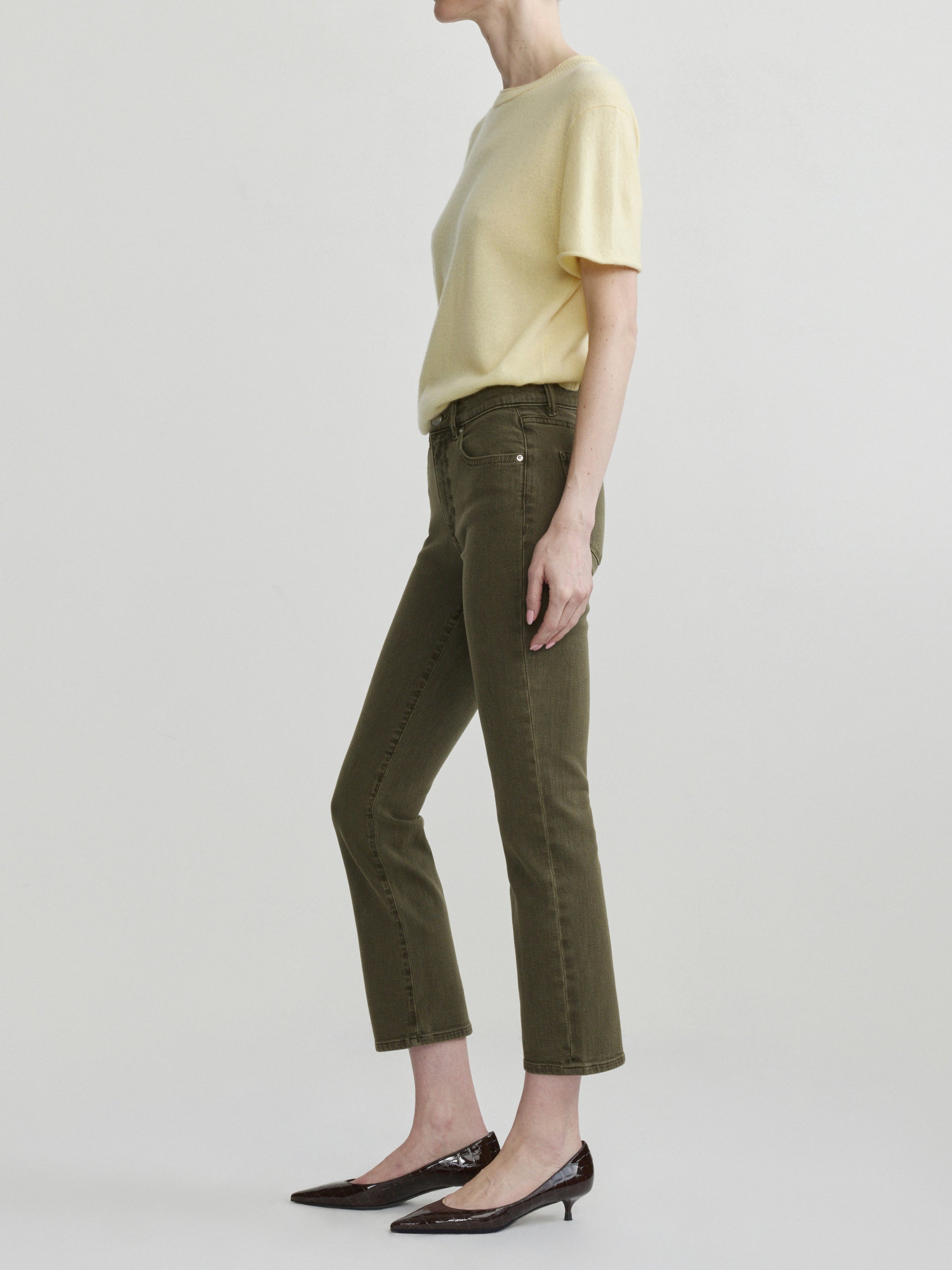 Mara Straight jeans in Pine with Knit Tee in Moonlight on a model, full-length side view in studio.