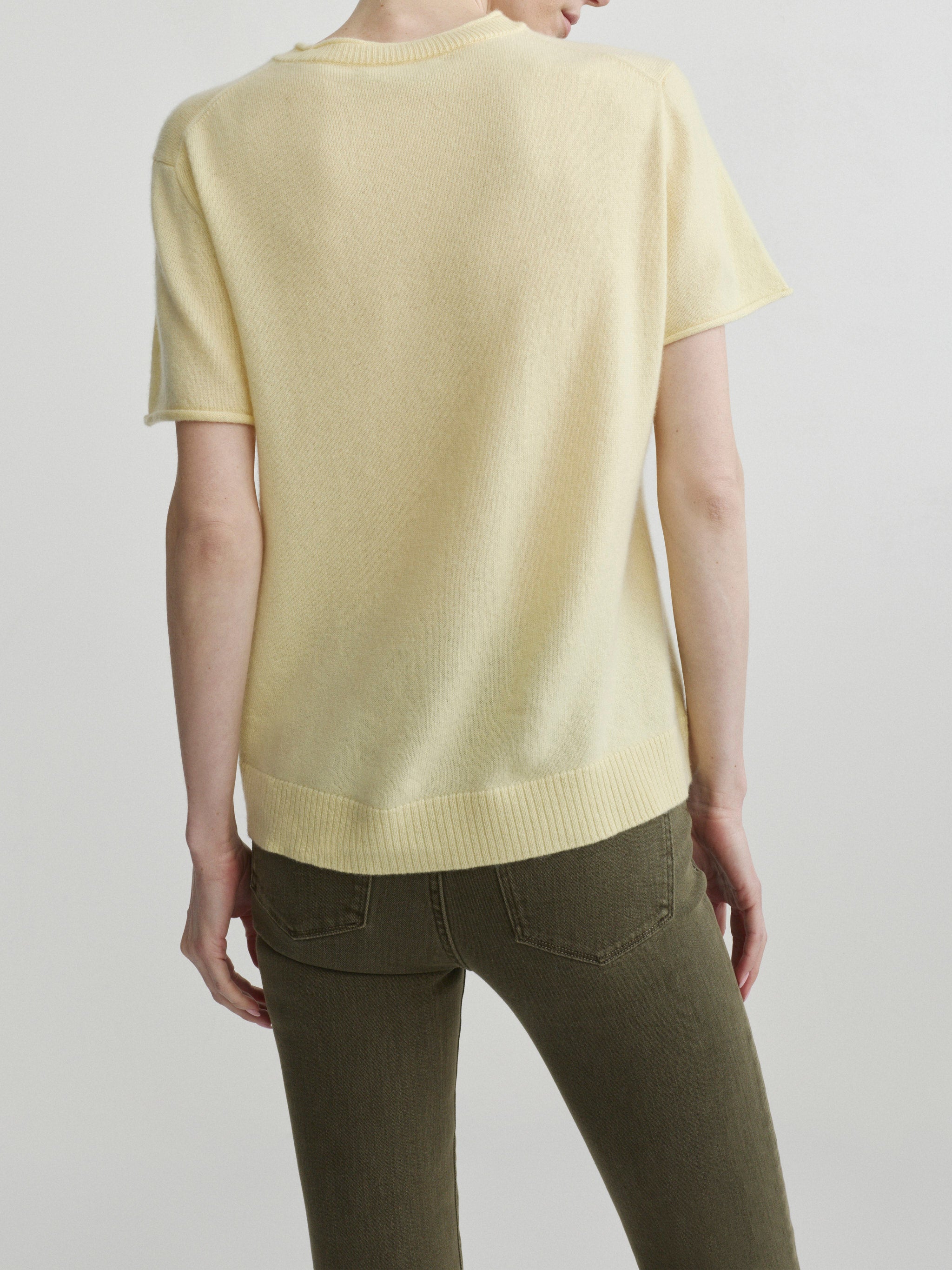 Mara Straight jeans in Pine with Knit Tee in Moonlight on a model, back view portrait in studio.