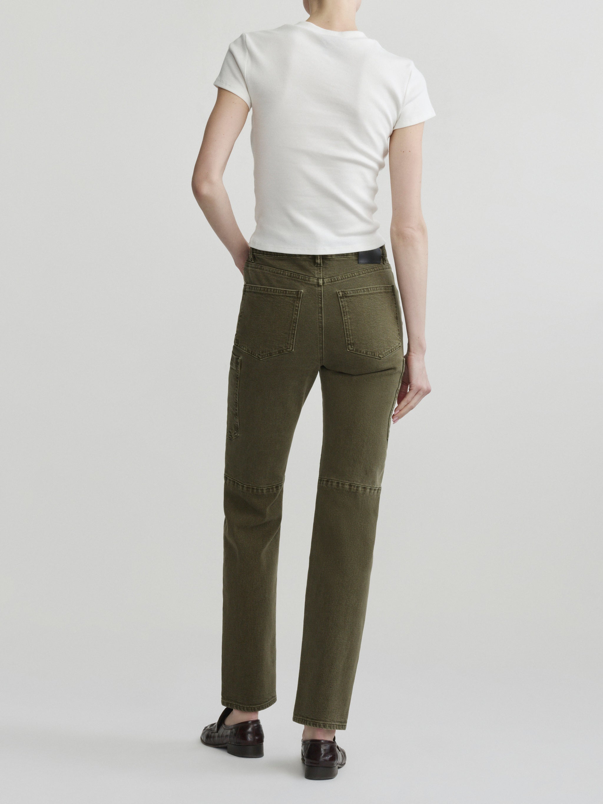 Devon Cigarette jeans in Pine with white tee on a model, full-length back view in studio.