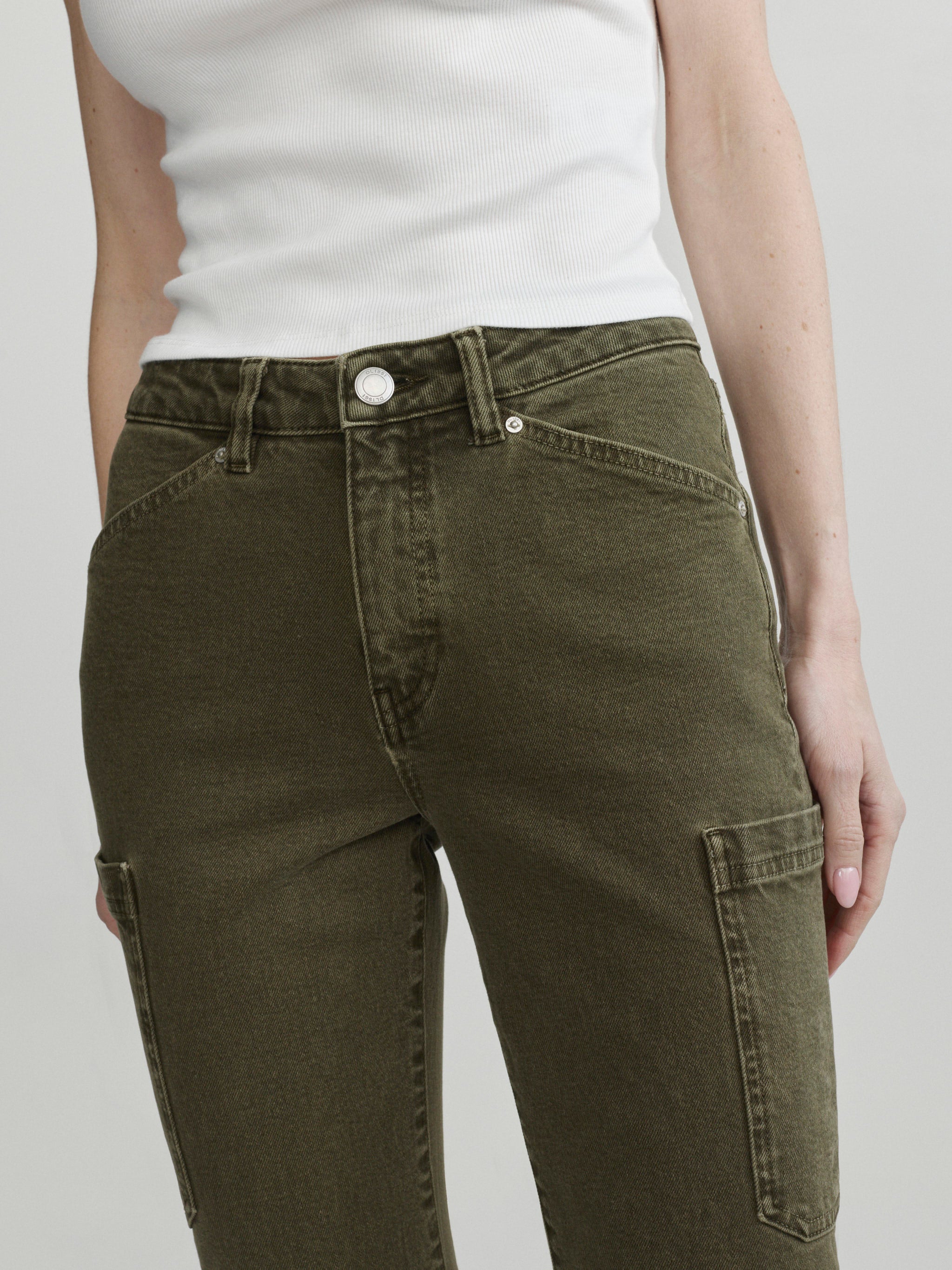 Devon Cigarette jeans in Pine on a model, close-up front view of waist and cargo pocket.