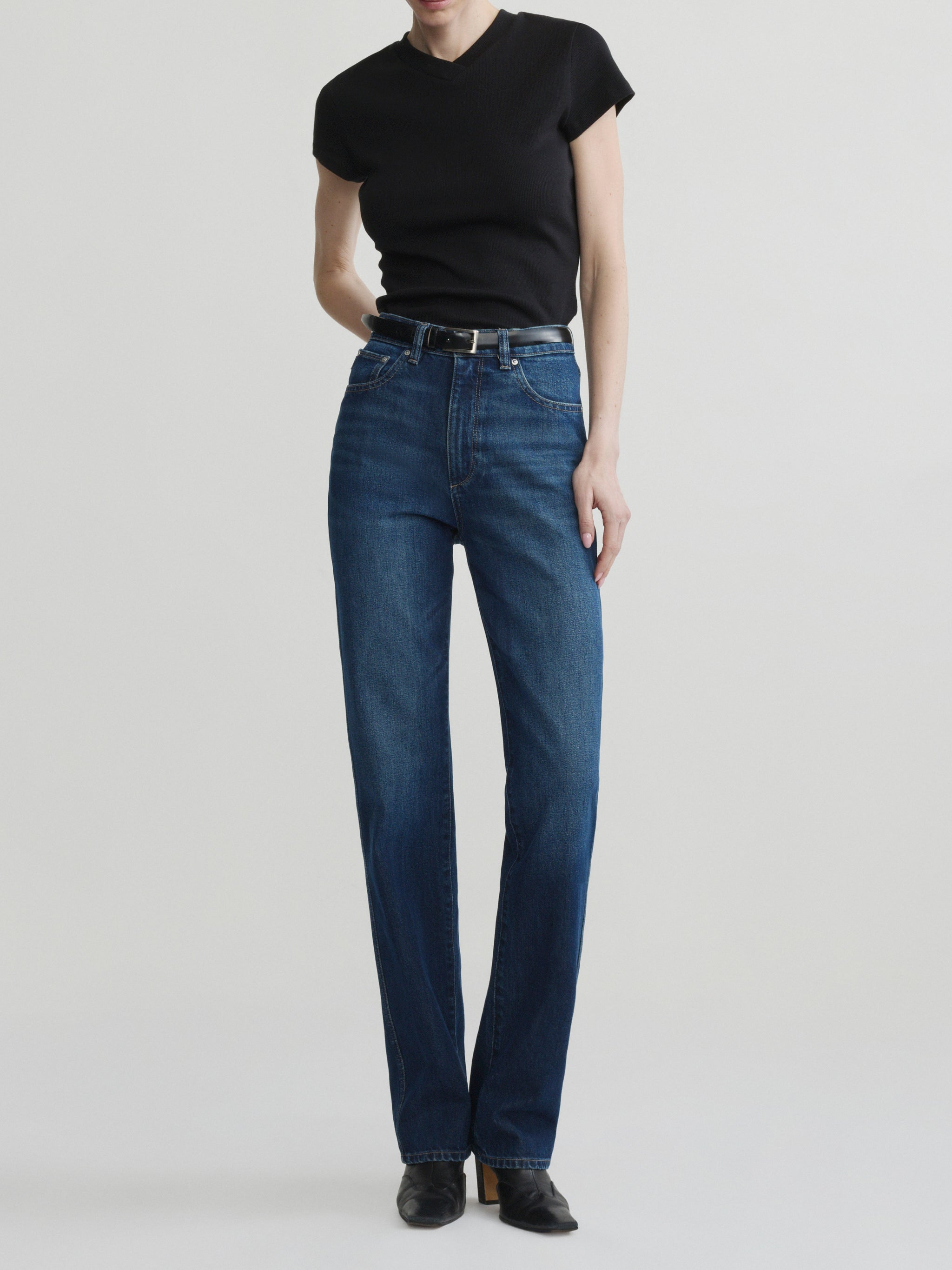 Cate Slim jeans in December with black tee and belt on a model, full-length front view in studio.
