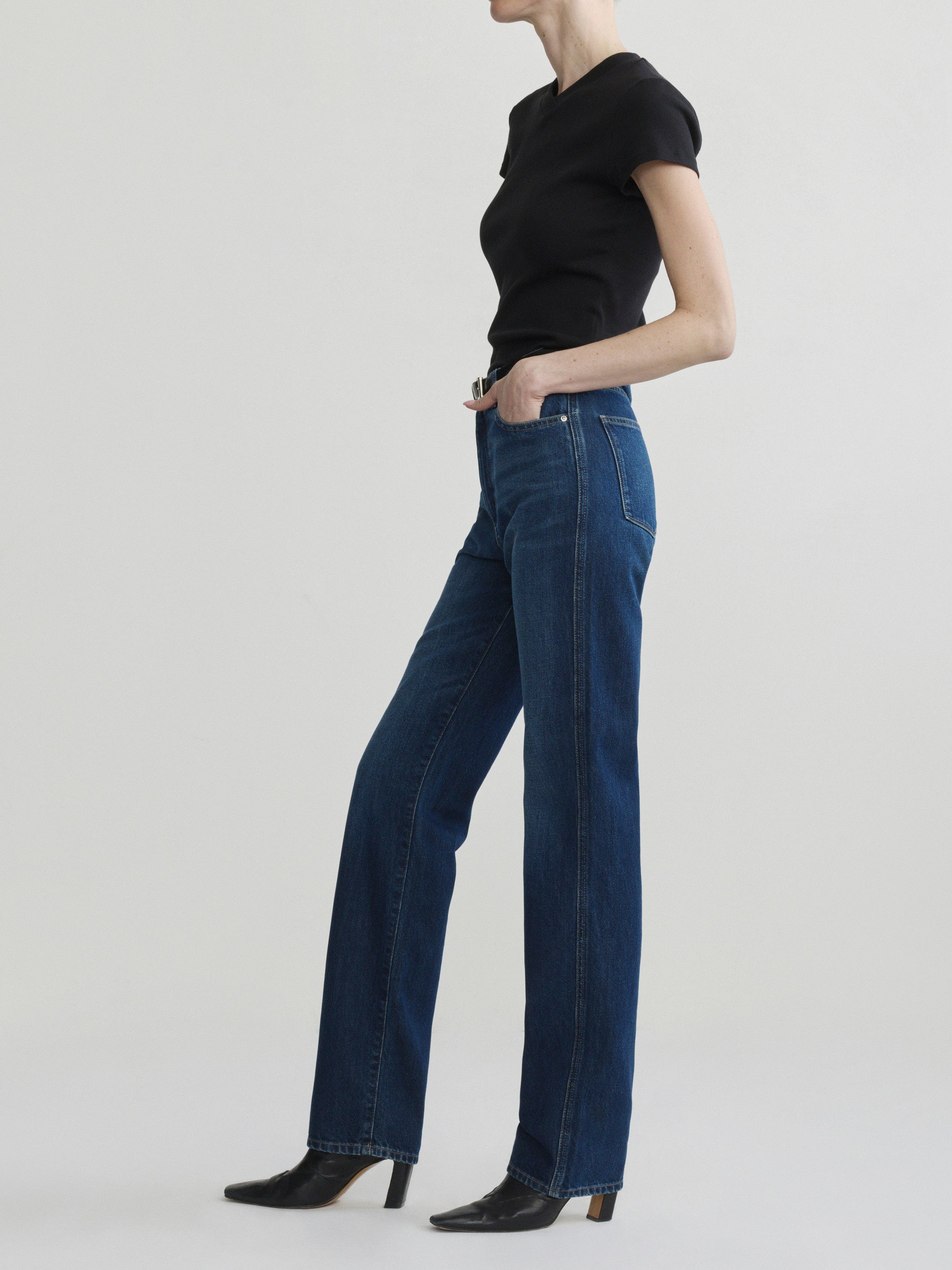 Cate Slim jeans in December with black tee on a model, full-length side view in studio.