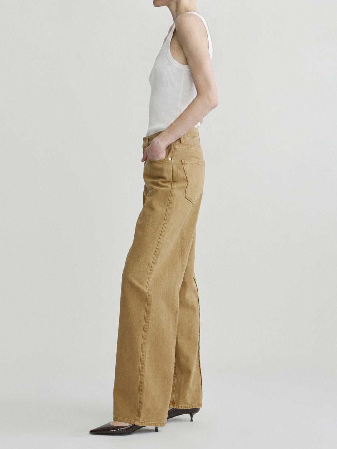Kaylen Soft Curve jeans in Savannas with a white tank top, model in side view, studio.