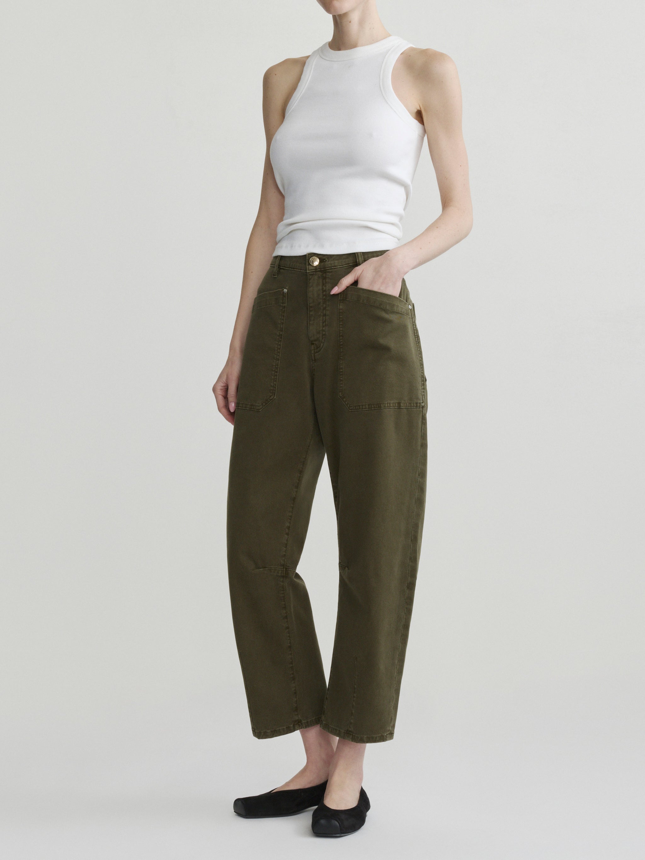 Bilie Easy Barrel jeans in Pine on a model with white tank top, three-quarter front view in studio.