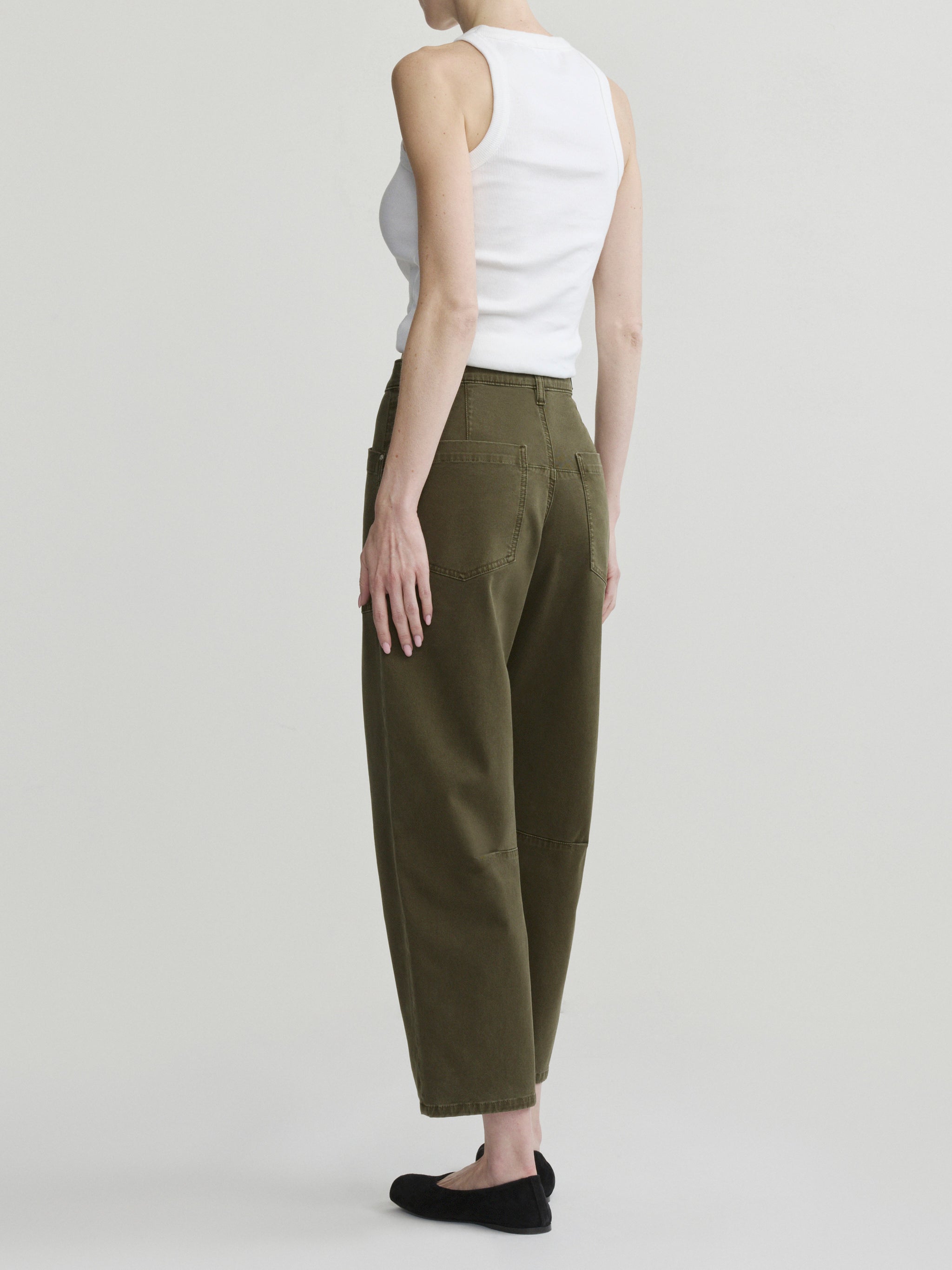 Bilie Easy Barrel jeans in Pine on a model with white tank top, three-quarter back view in studio.