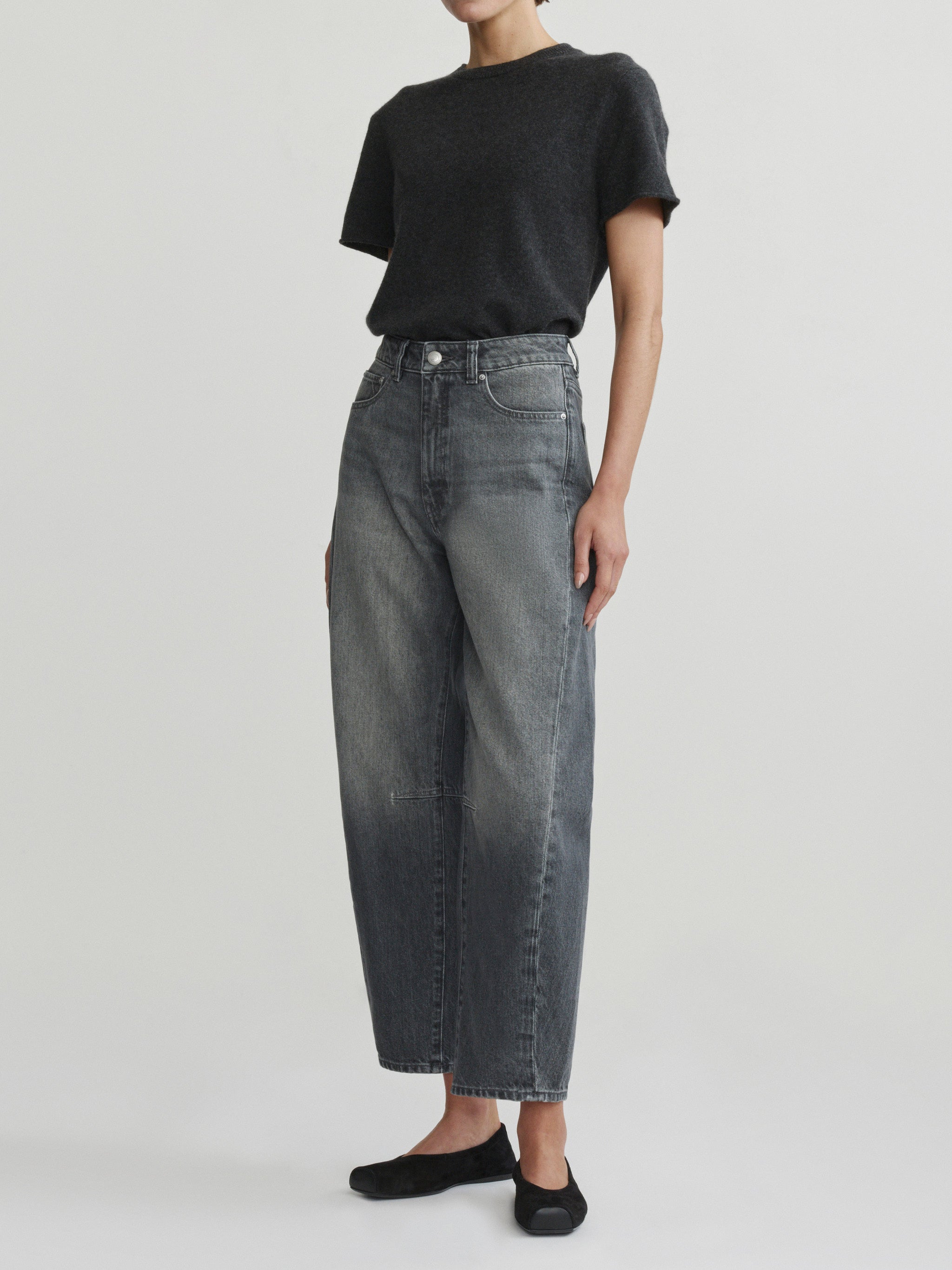 Miro Barrel jeans in Ash Grey on a model with charcoal tee, three-quarter front view in studio.