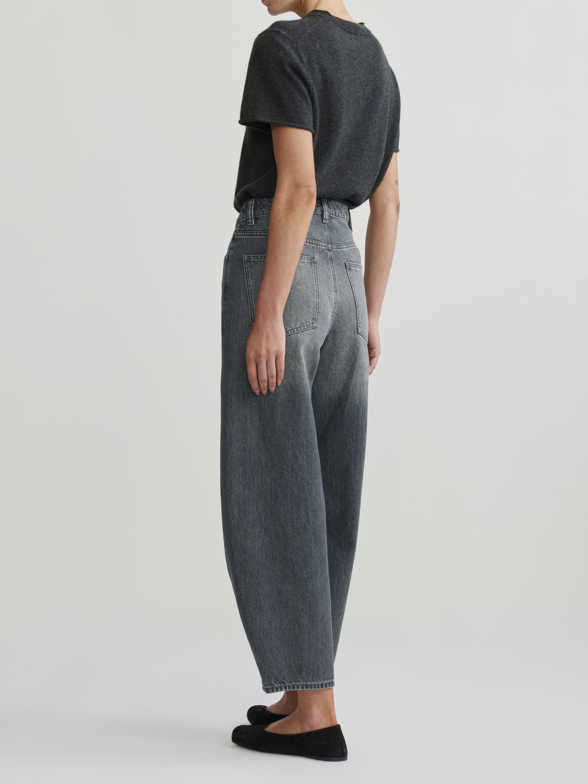 Miro Barrel jeans in Ash Grey on a model with charcoal tee, full-length back view in studio.