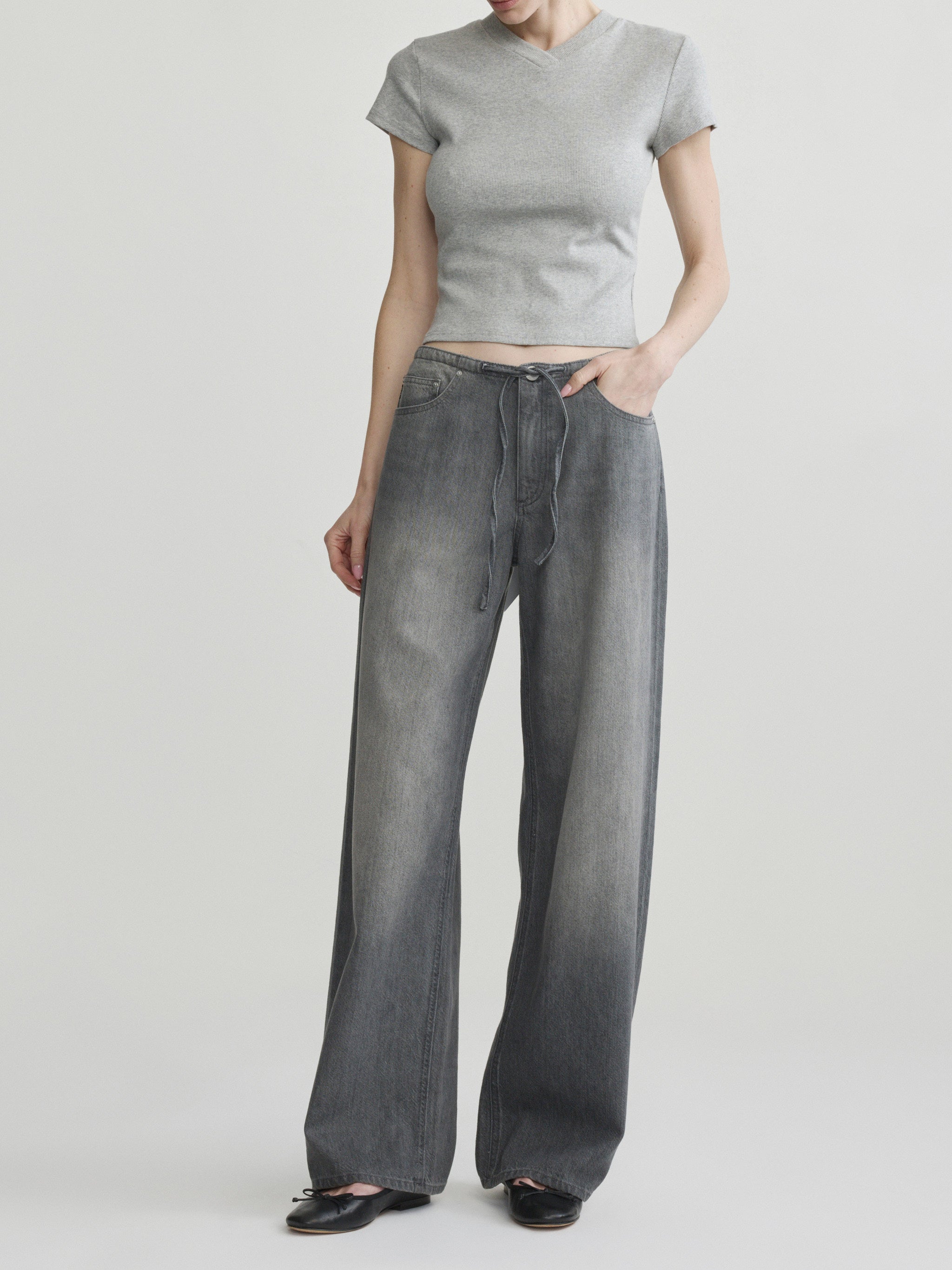 Sienna Low-Slung Wide Leg jeans in Ash Grey Aura on a model with grey tee, full-length front view.