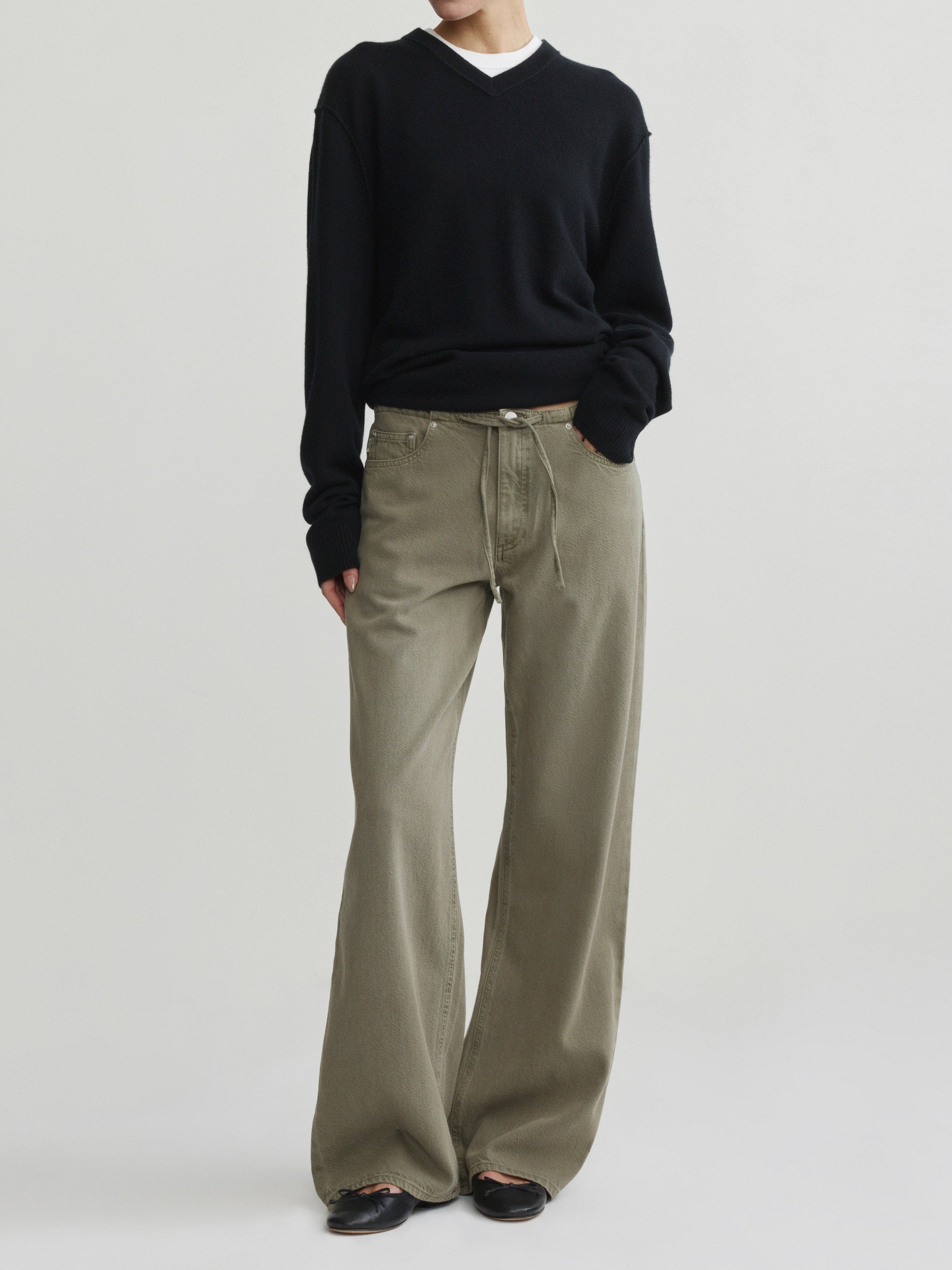 Sienna Low-Slung Wide Leg jeans in Clover Aura on a model in black sweater, full-length front view.