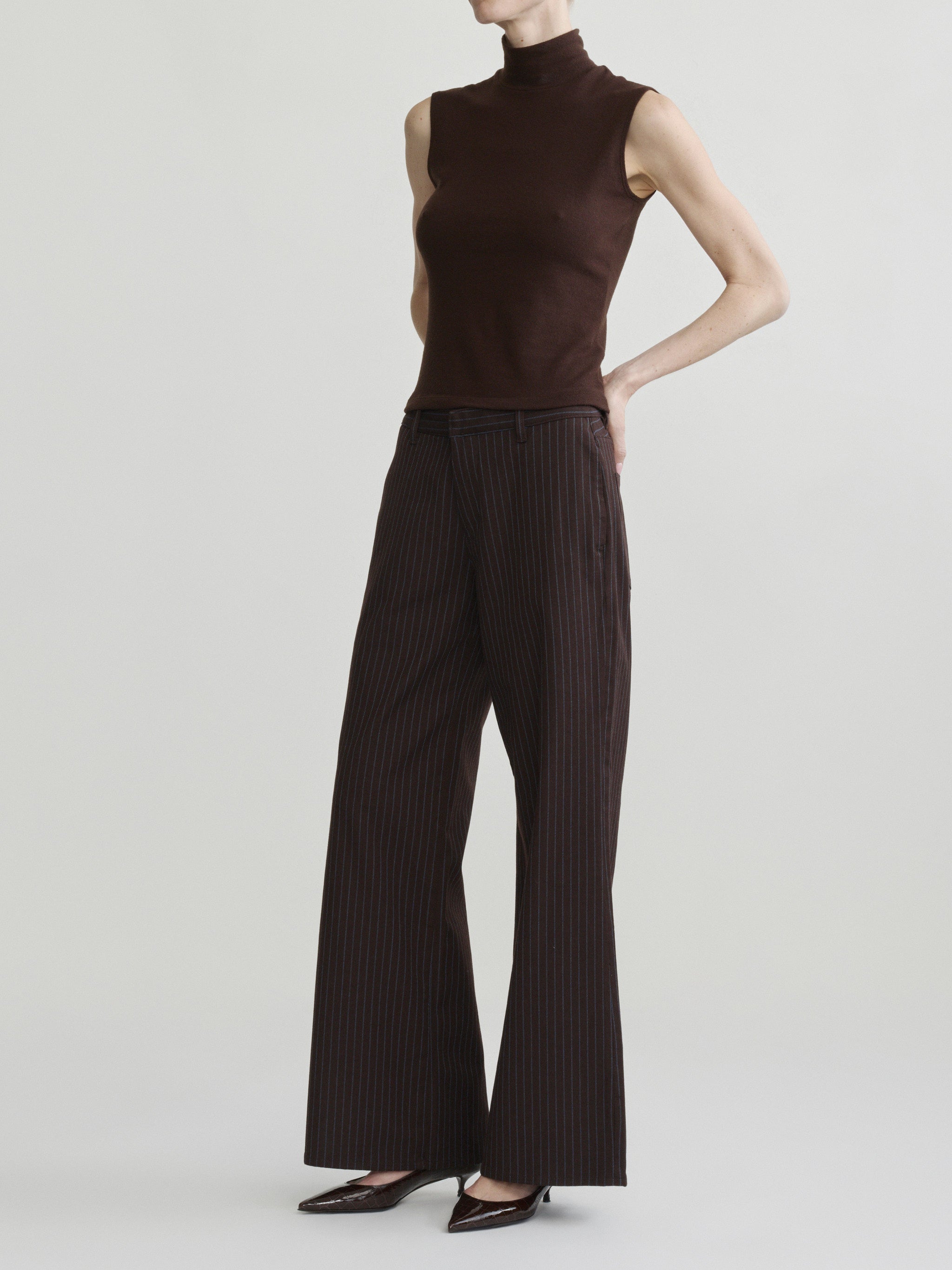 Alex Baggy Wide Leg jeans in Brown Blue Stripe on a model in brown mock-neck top, full-length side view.
