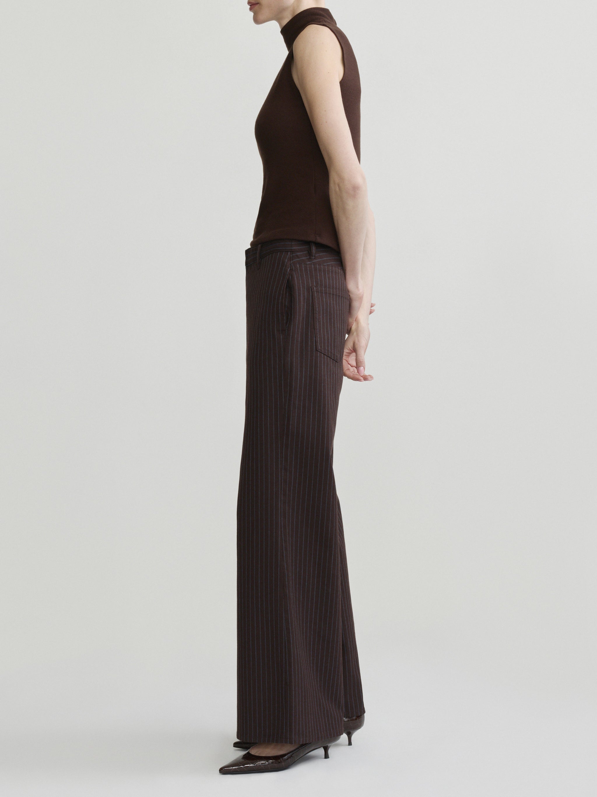 Alex Baggy Wide Leg jeans in Brown Blue Stripe on a model in brown mock-neck top, full-length side view.