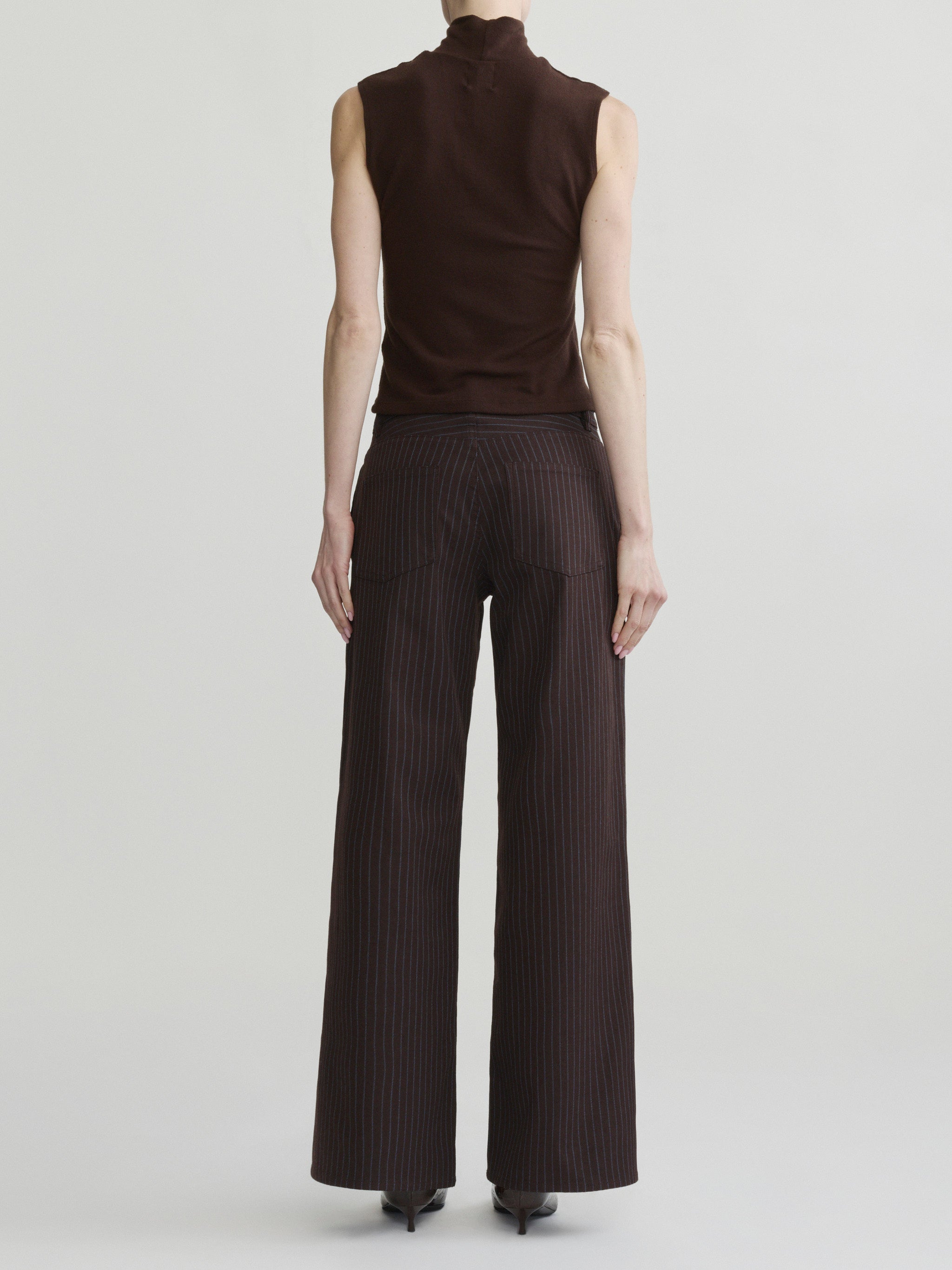 Alex Baggy Wide Leg jeans in Brown Blue Stripe on a model in brown top, full-length back view.