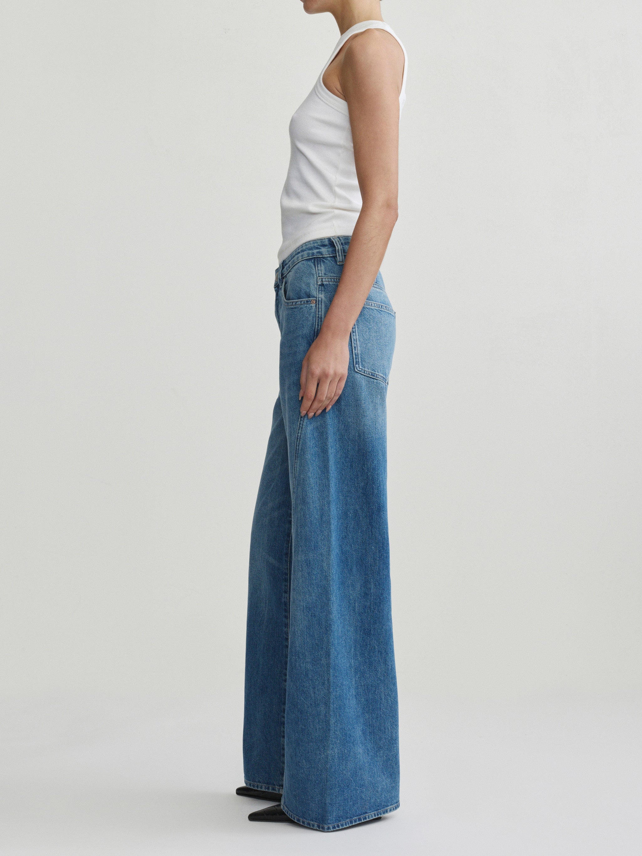 Alex Baggy Wide Leg jeans in Authentic on a model in white tank top, full-length side view.