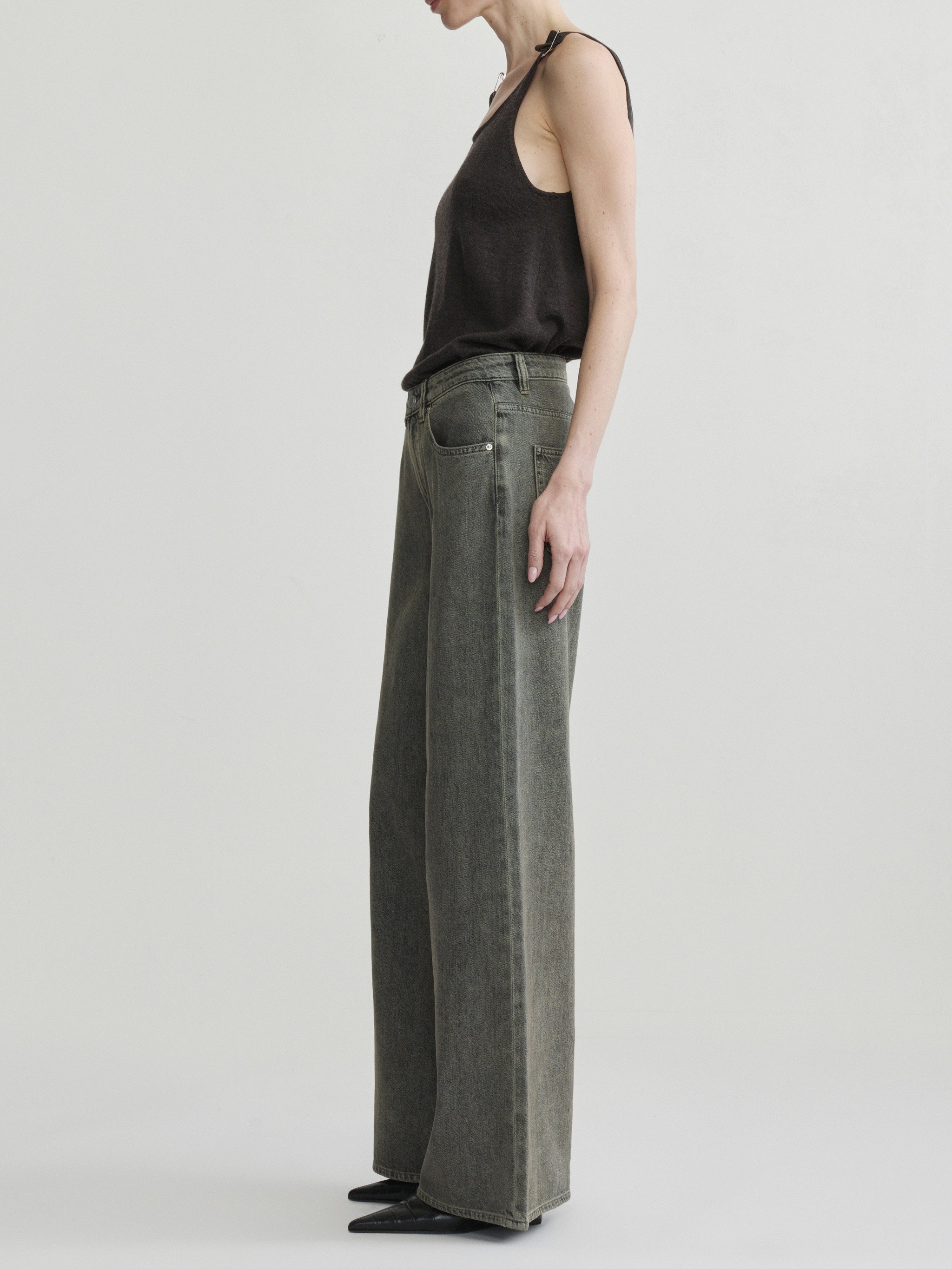 Alex Baggy Wide Leg jeans in Character Green Aura on a model in black tank top, full-length side view.