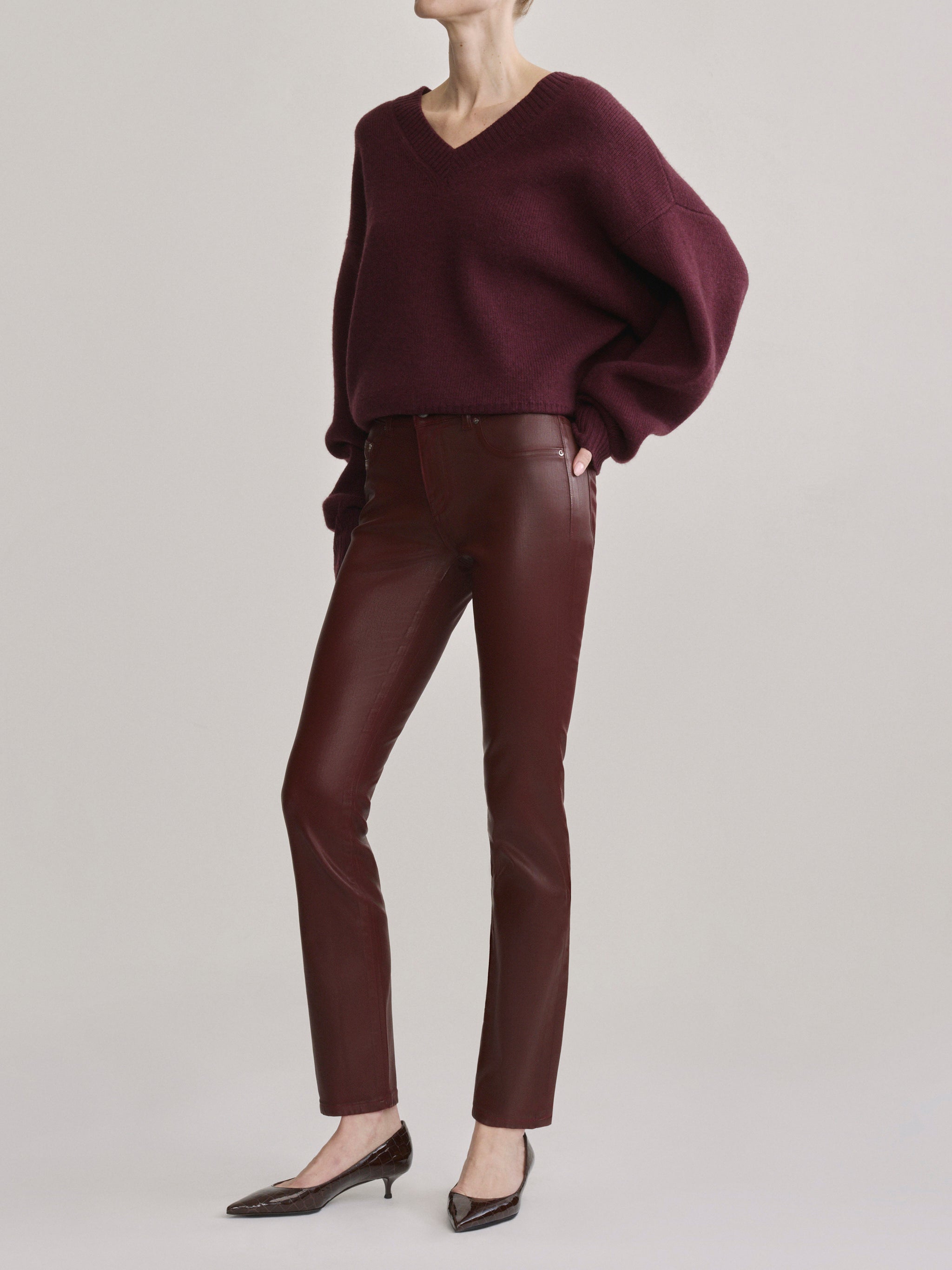 DL1961 Jessica Skinny Low-Rise coated jeans in Burgundy Coated, wine finish, angled front view.