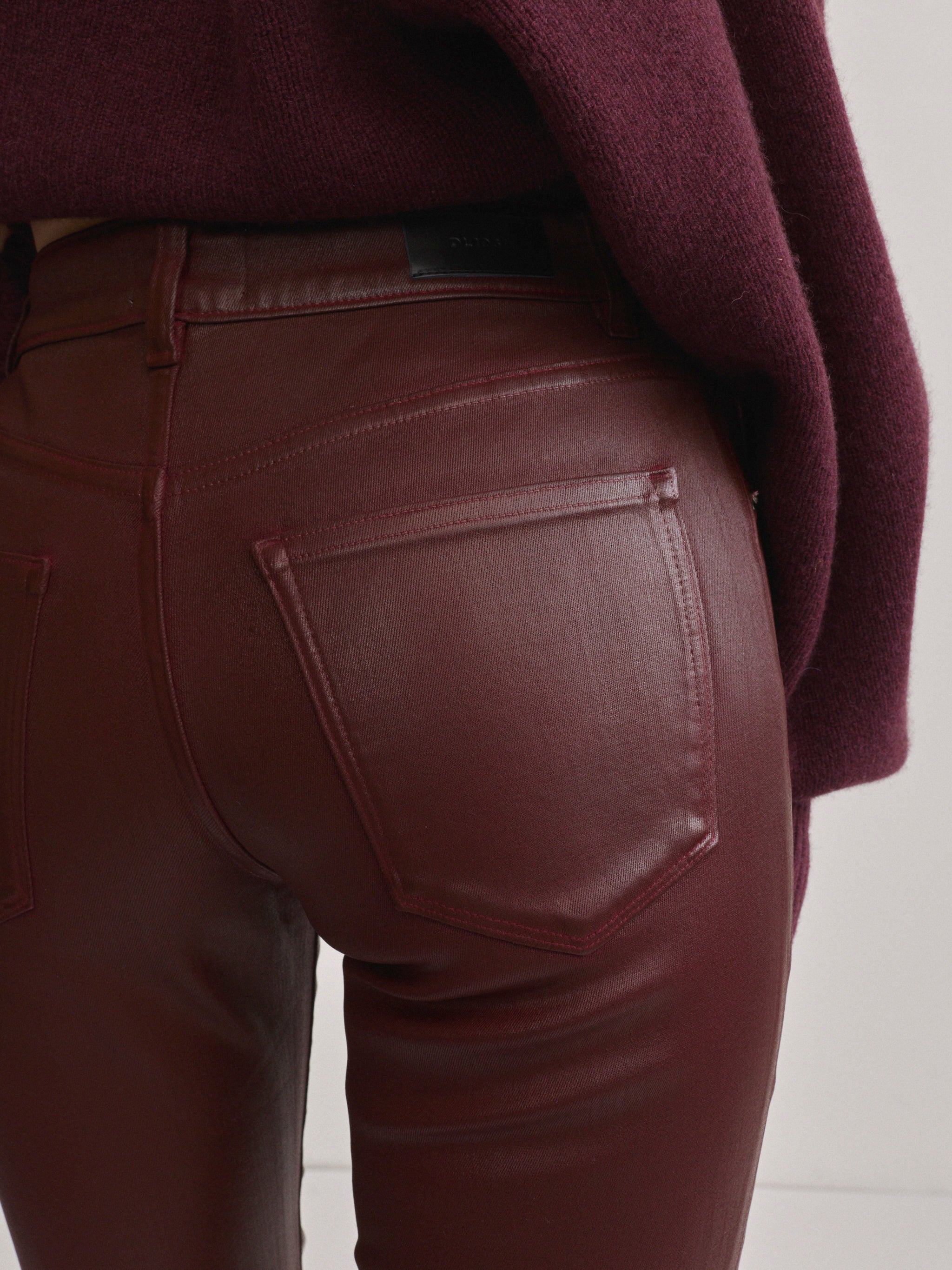 DL1961 Jessica Skinny Low-Rise coated jeans in Burgundy Coated, close-up of glossy back pocket.