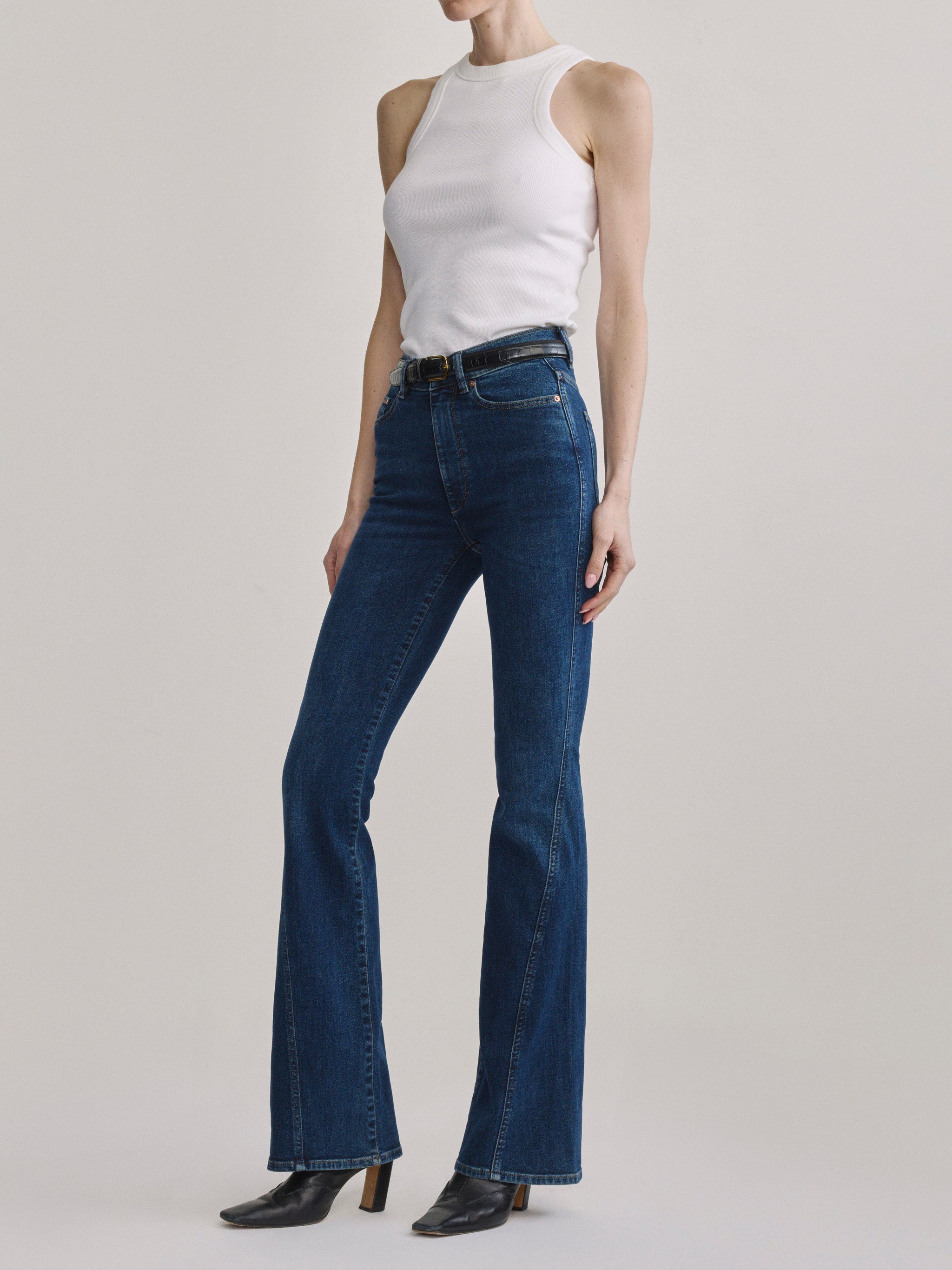 Bridget Boot Breeze Seamed jeans with the High Neck Ribbed Tank in White, full-length three-quarter front view.