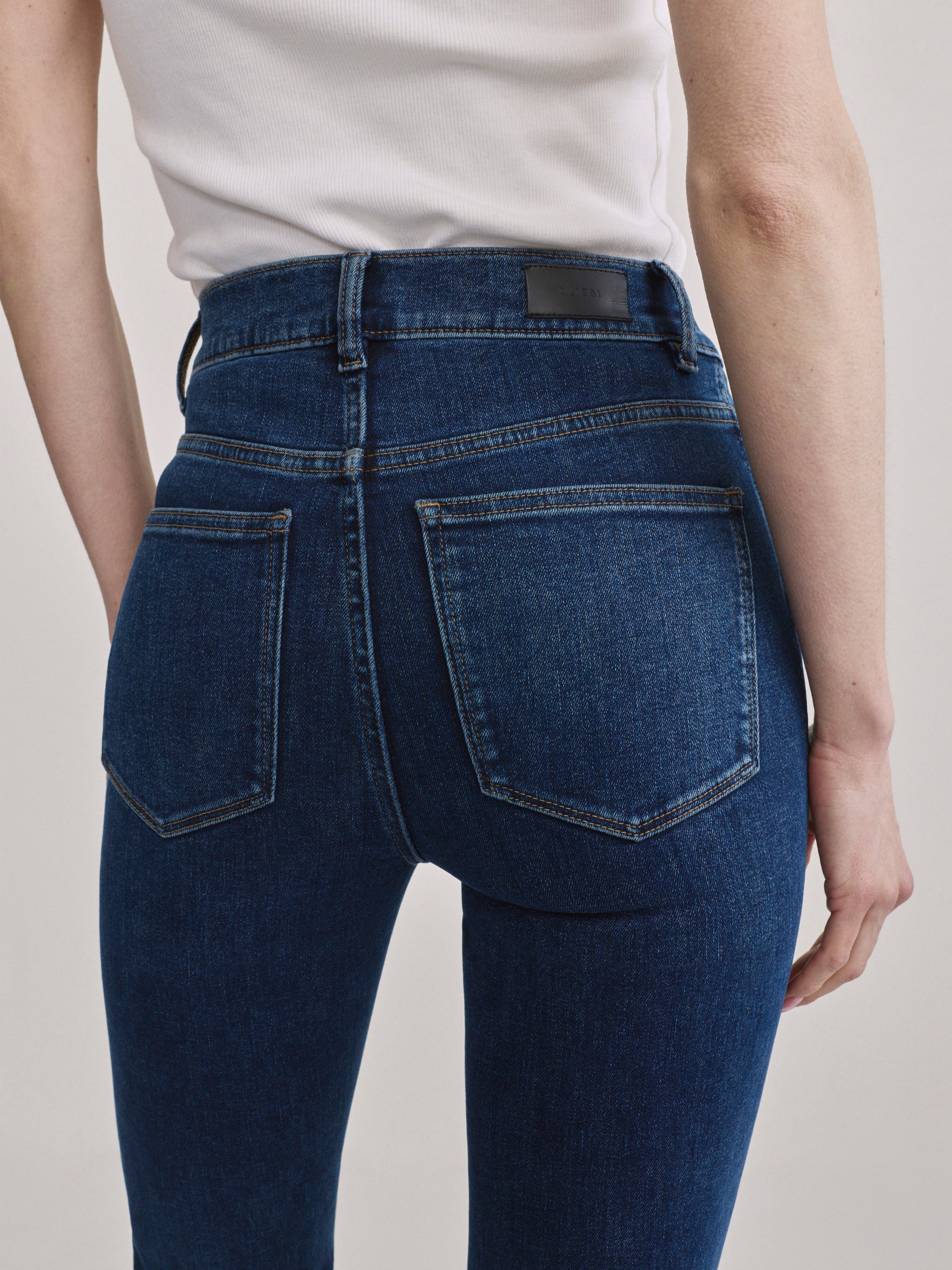 Bridget Boot Breeze Seamed jeans, close-up back view of the pockets on a model.