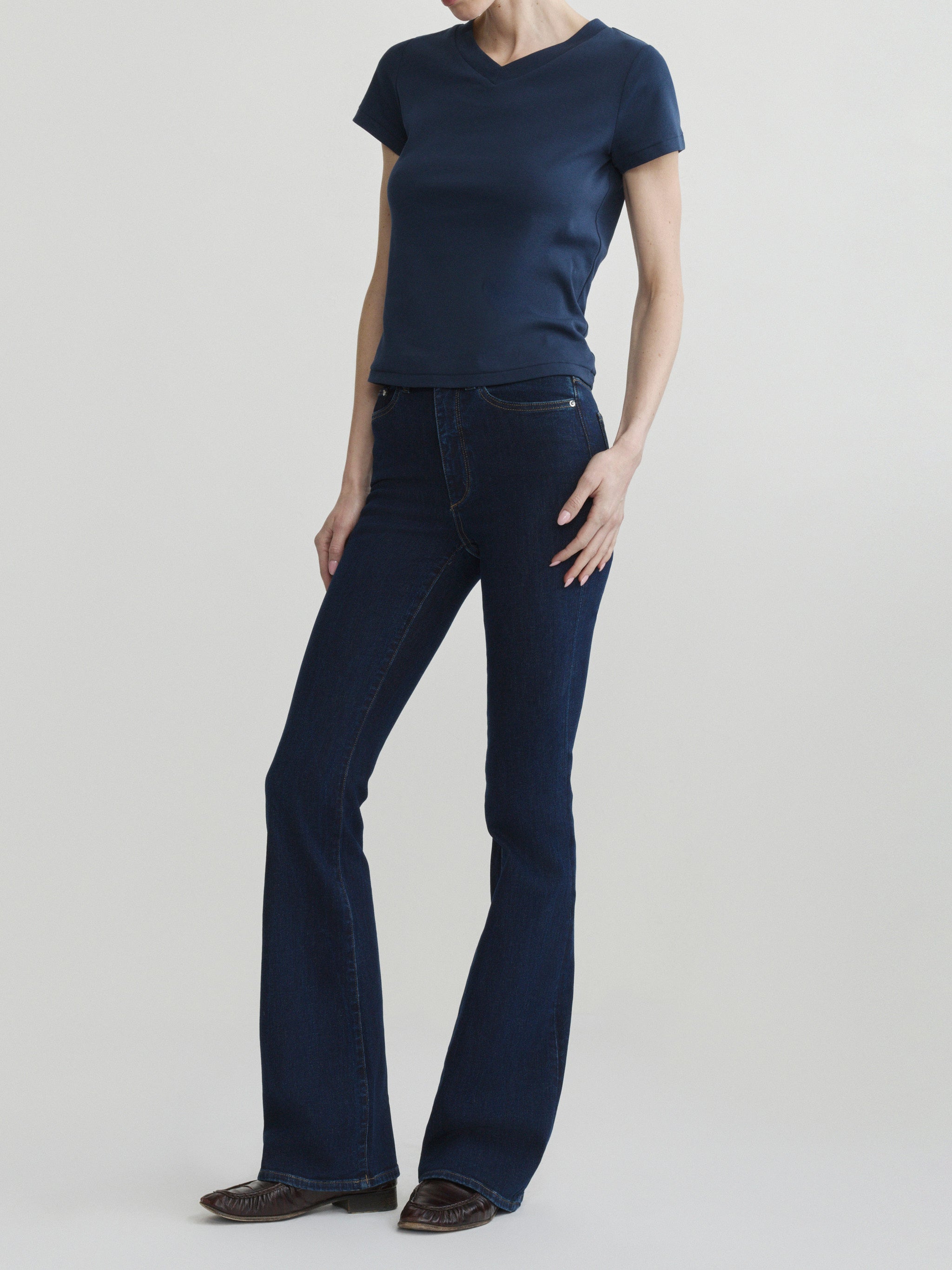 Bridget Boot jeans in Night Out with Shrunken V-Neck Tee in Navy, full-length front view on a model.