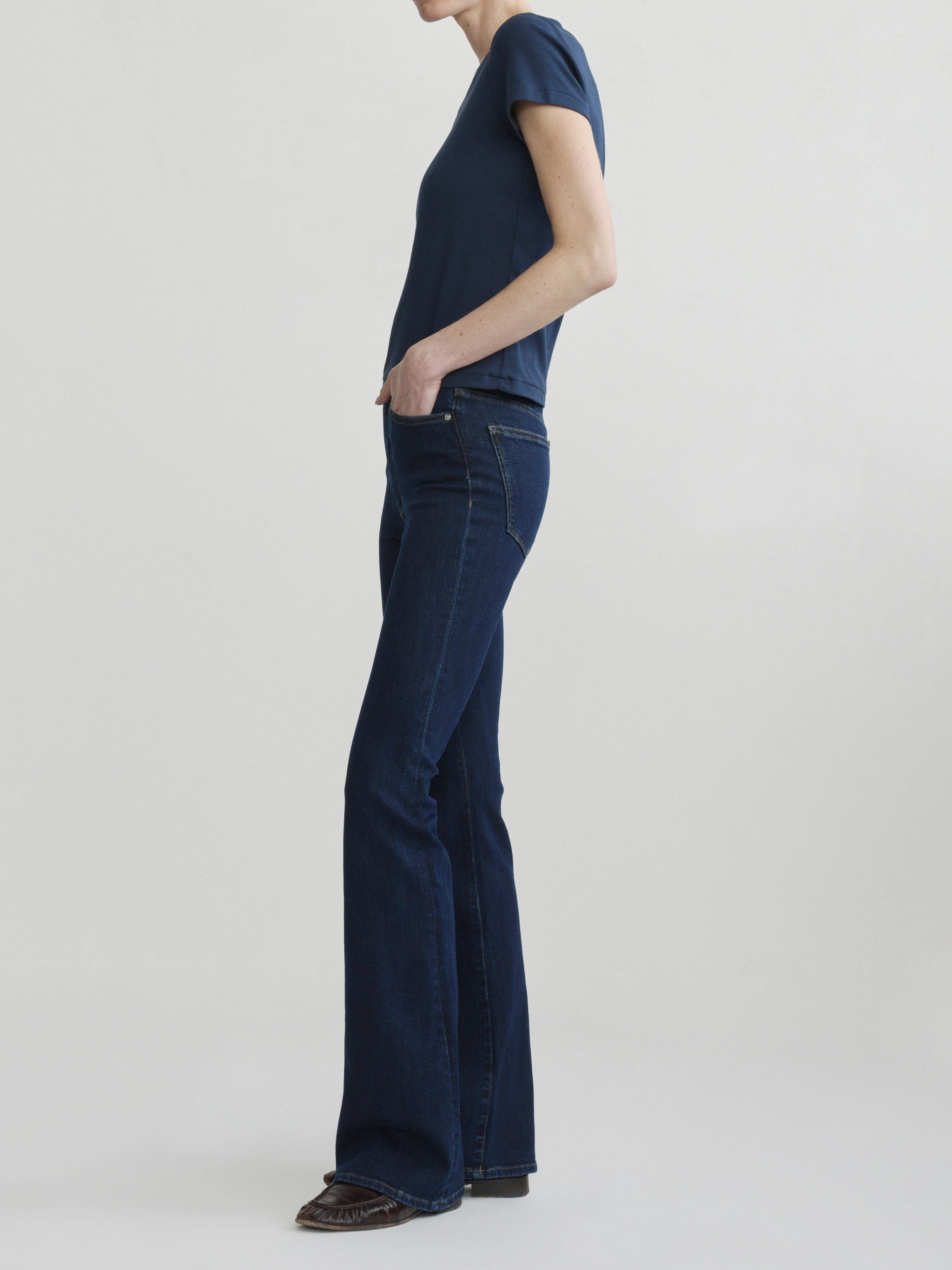 Bridget Boot jeans in Night Out with Shrunken V-Neck Tee in Navy, full-length side view on a model.