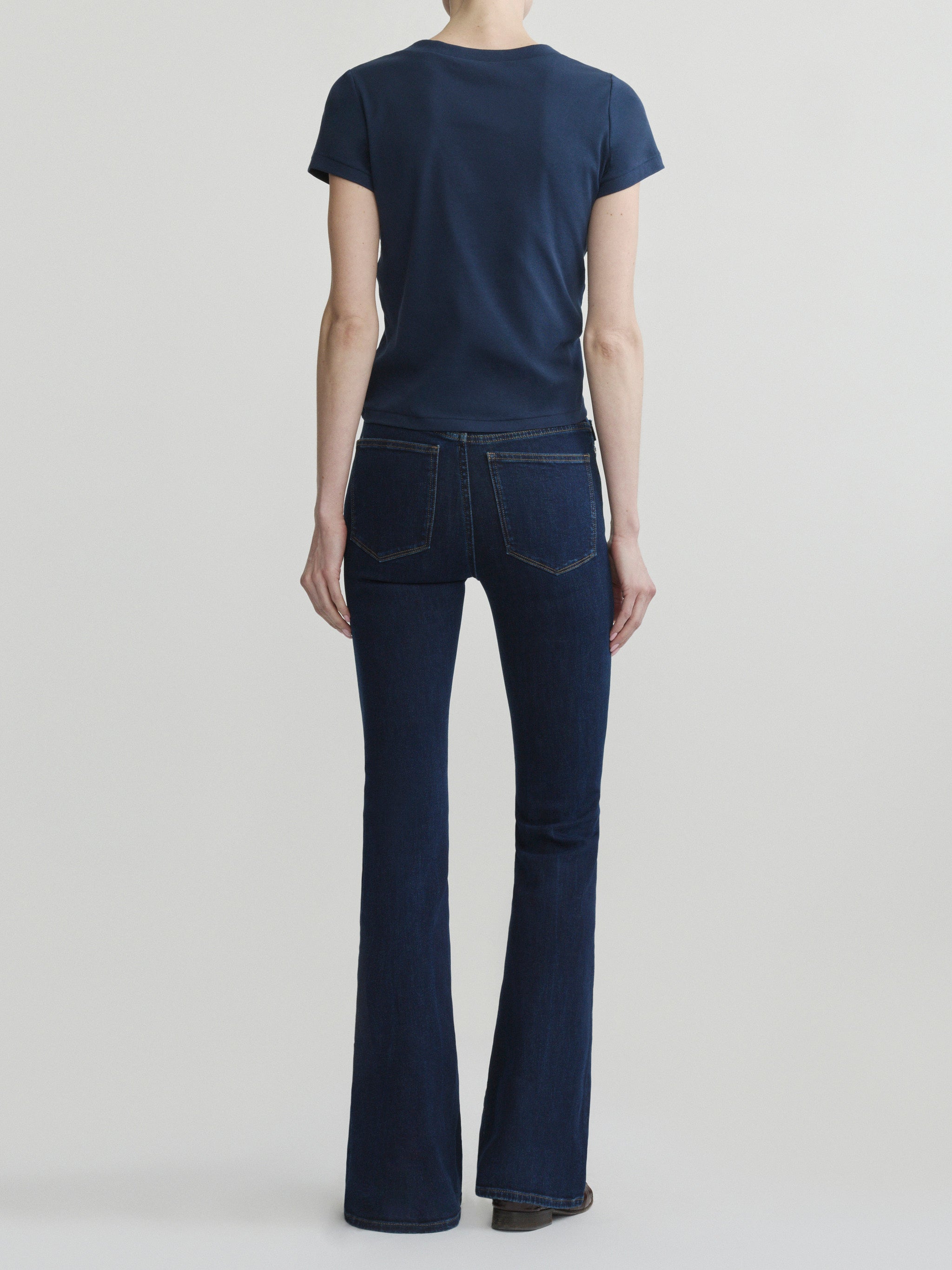 Bridget Boot jeans in Night Out with Shrunken V-Neck Tee in Navy, full-length back view on a model.