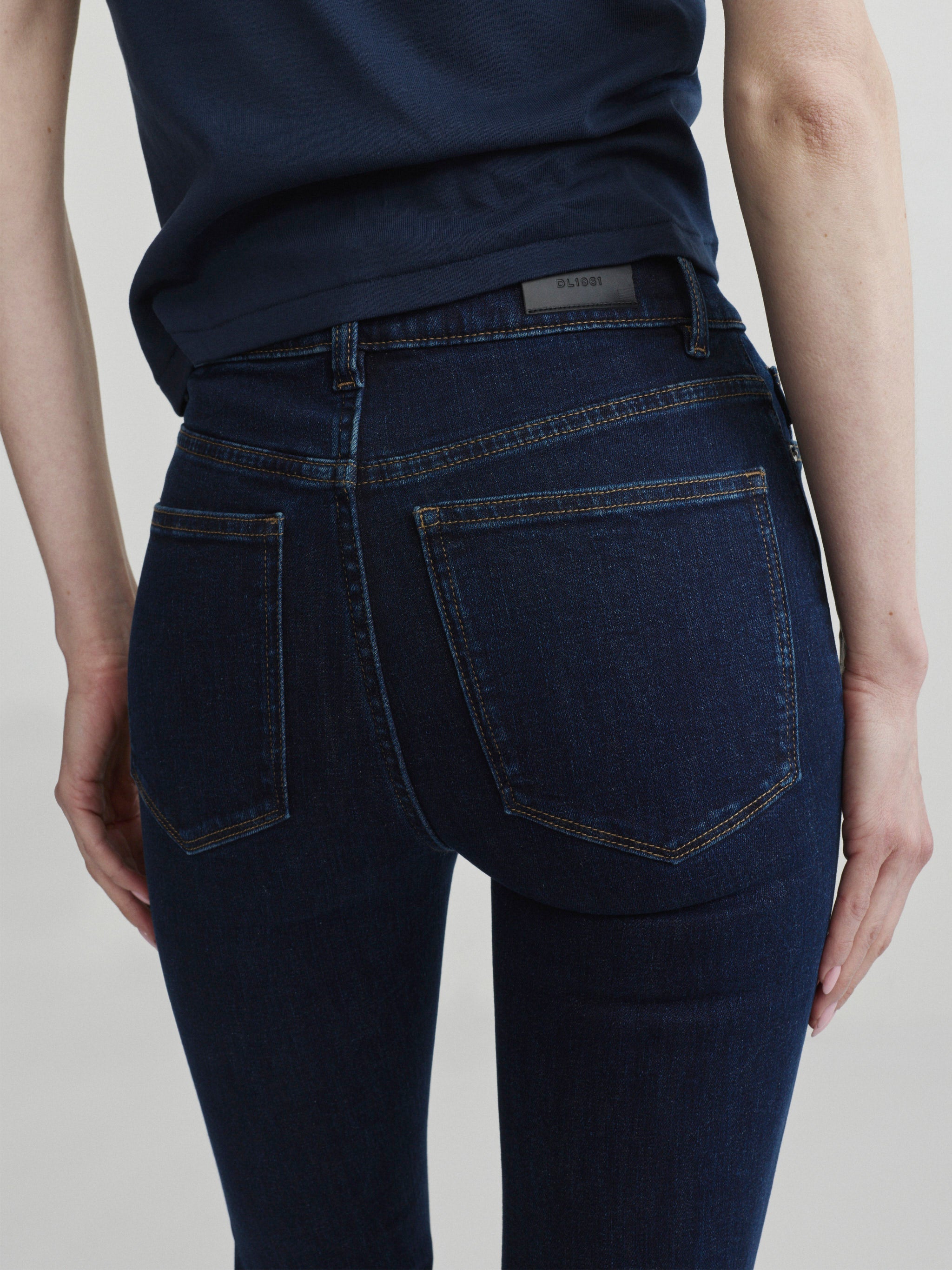 Bridget Boot jeans in Night Out with Navy tee, close-up of back pockets and logo patch.