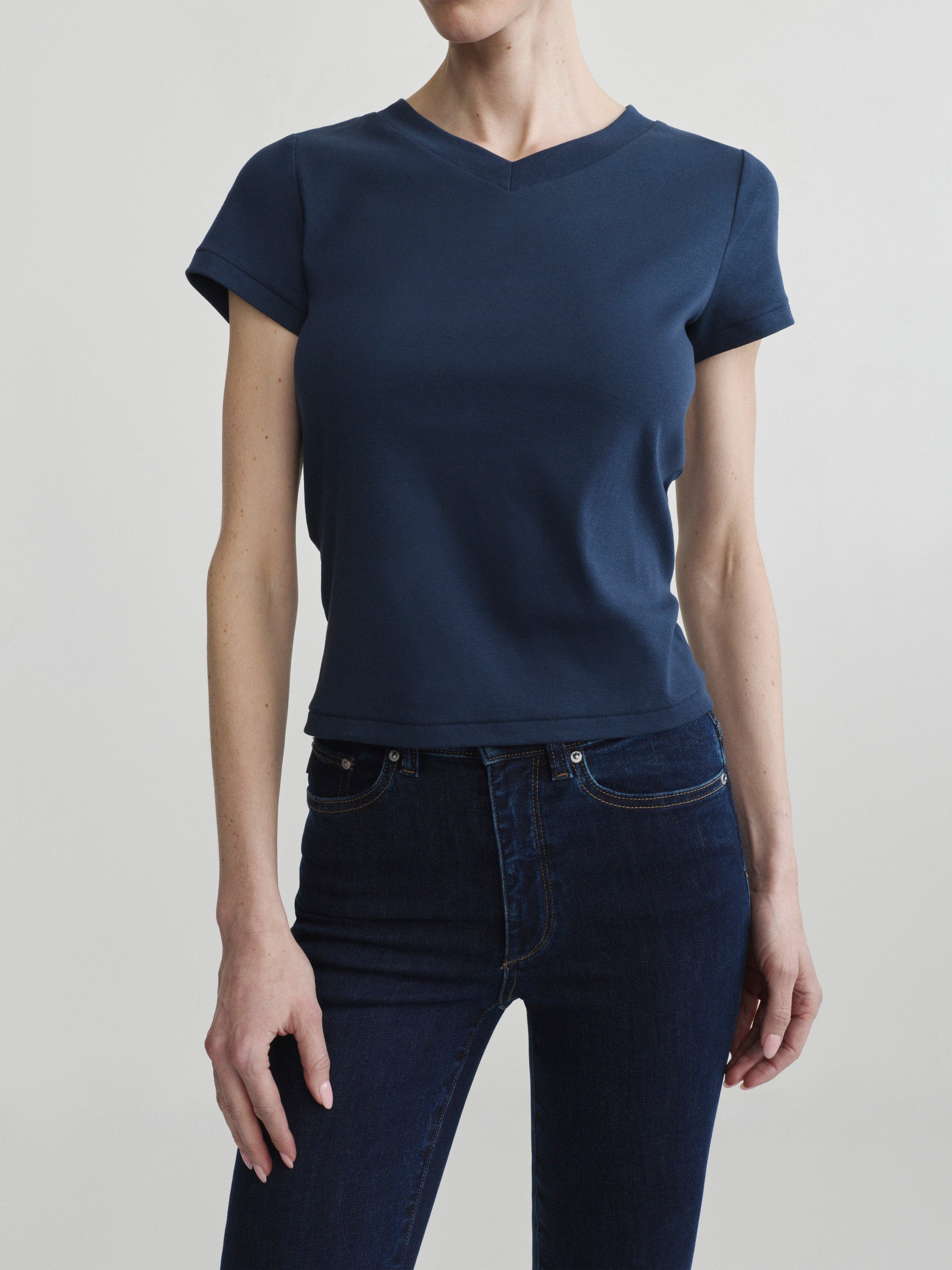 Shrunken V-Neck Tee in Navy with Bridget Boot jeans in Night Out, portrait front view on a model.