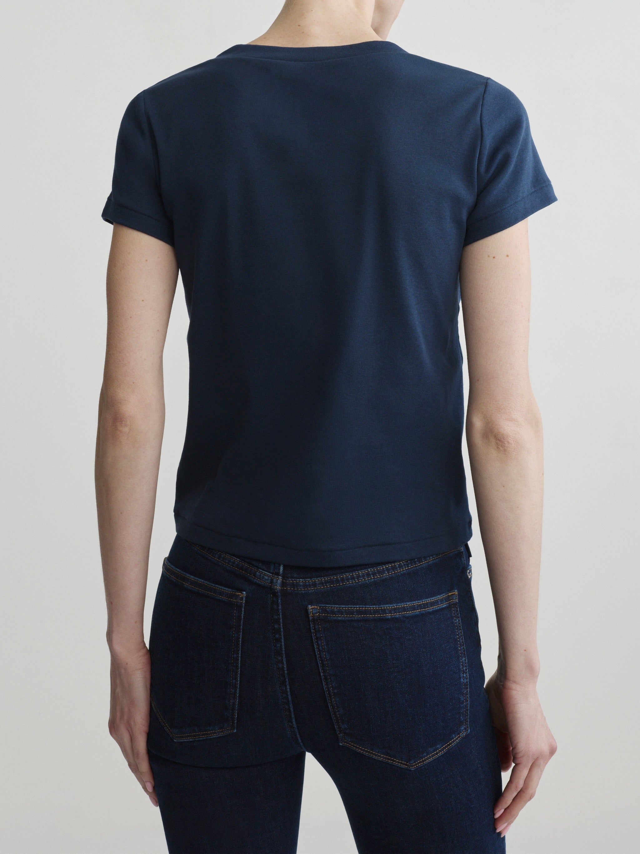 Shrunken V-Neck Tee in Navy with Bridget Boot jeans in Night Out, portrait back view on a model.