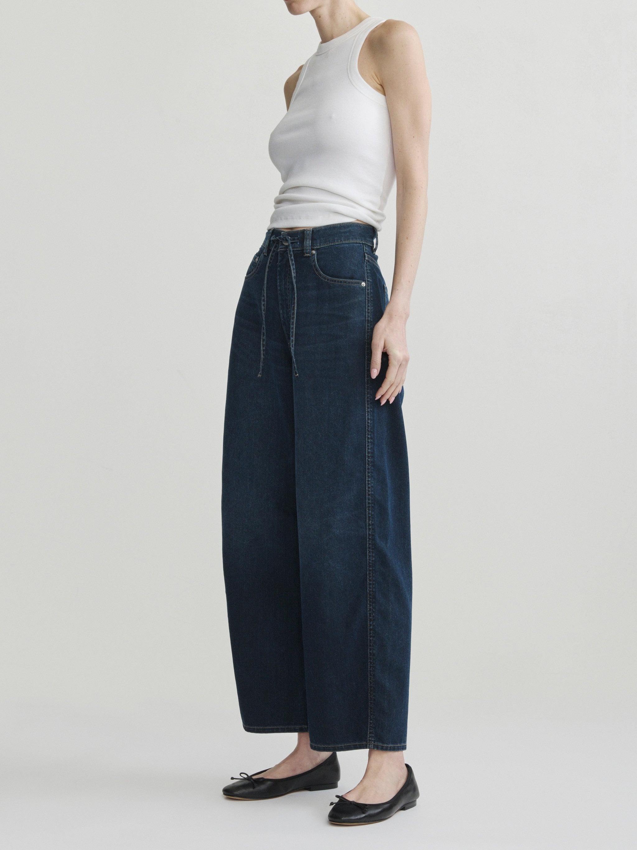 Taylor Relaxed Barrel jeans in Jazz Aura on a model in white tank top, full-length side view.