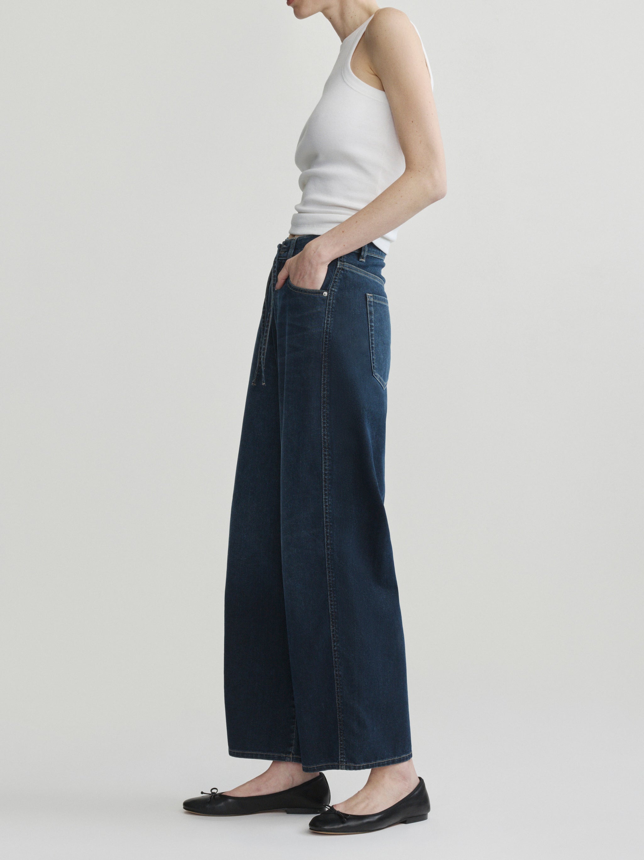 Taylor Relaxed Barrel jeans in Jazz Aura on a model in white tank top, full-length side view.