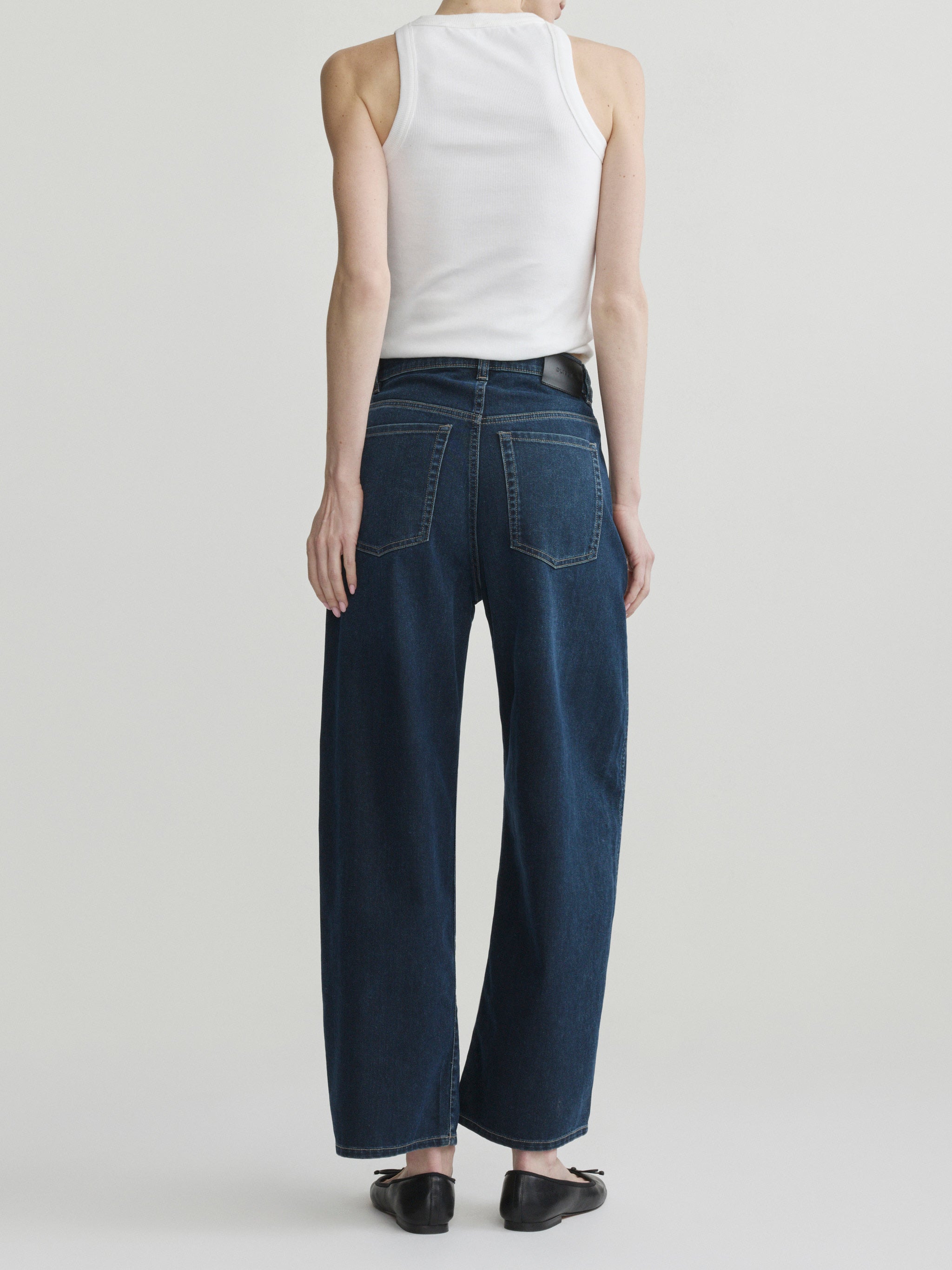 Taylor Relaxed Barrel jeans in Jazz Aura on a model in white tank top, full-length back view.