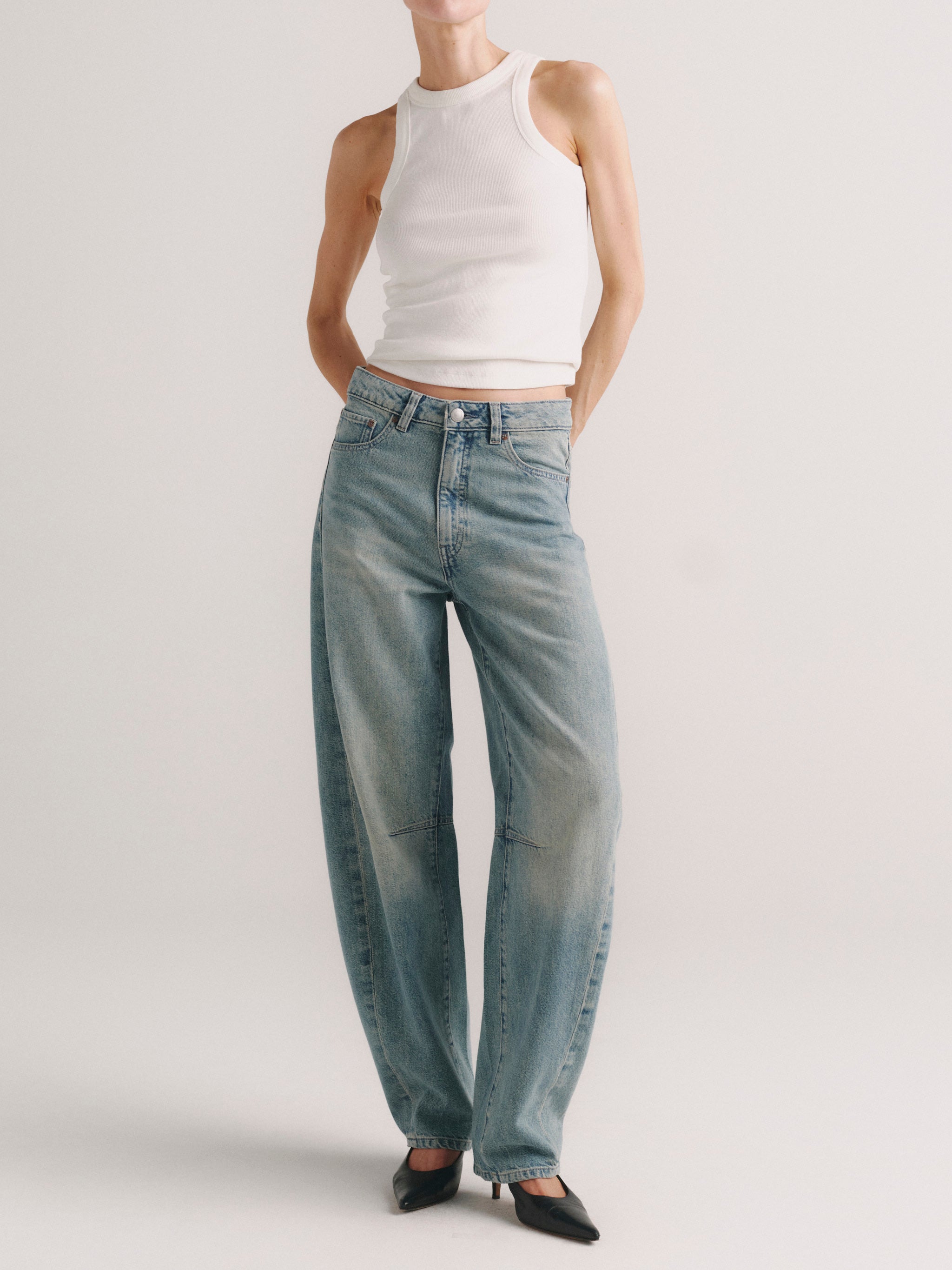 Miro Barrel jeans in Worn Day on a model in white tank top, full-length front view.