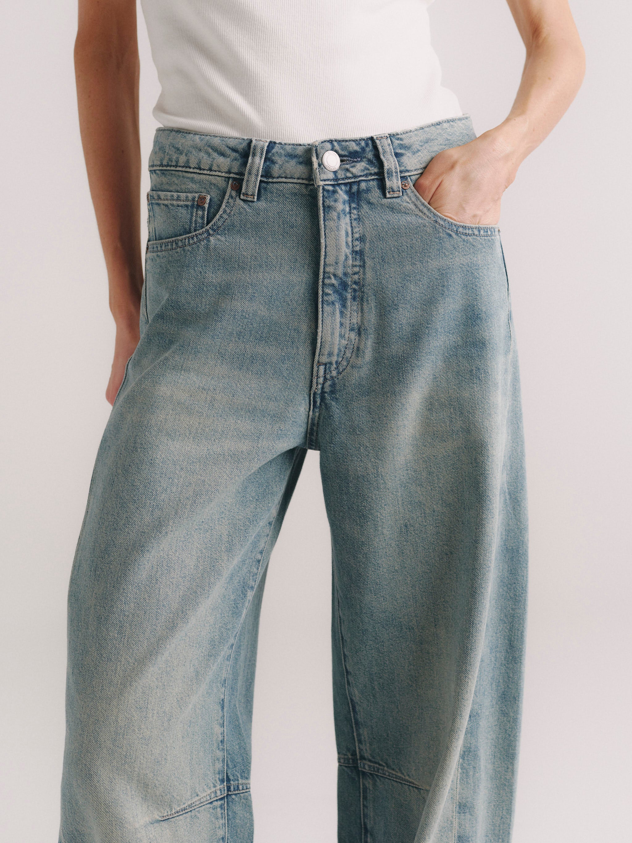 Miro Barrel jeans in Worn Day on a model, close-up of hip and thigh with hand in pocket.