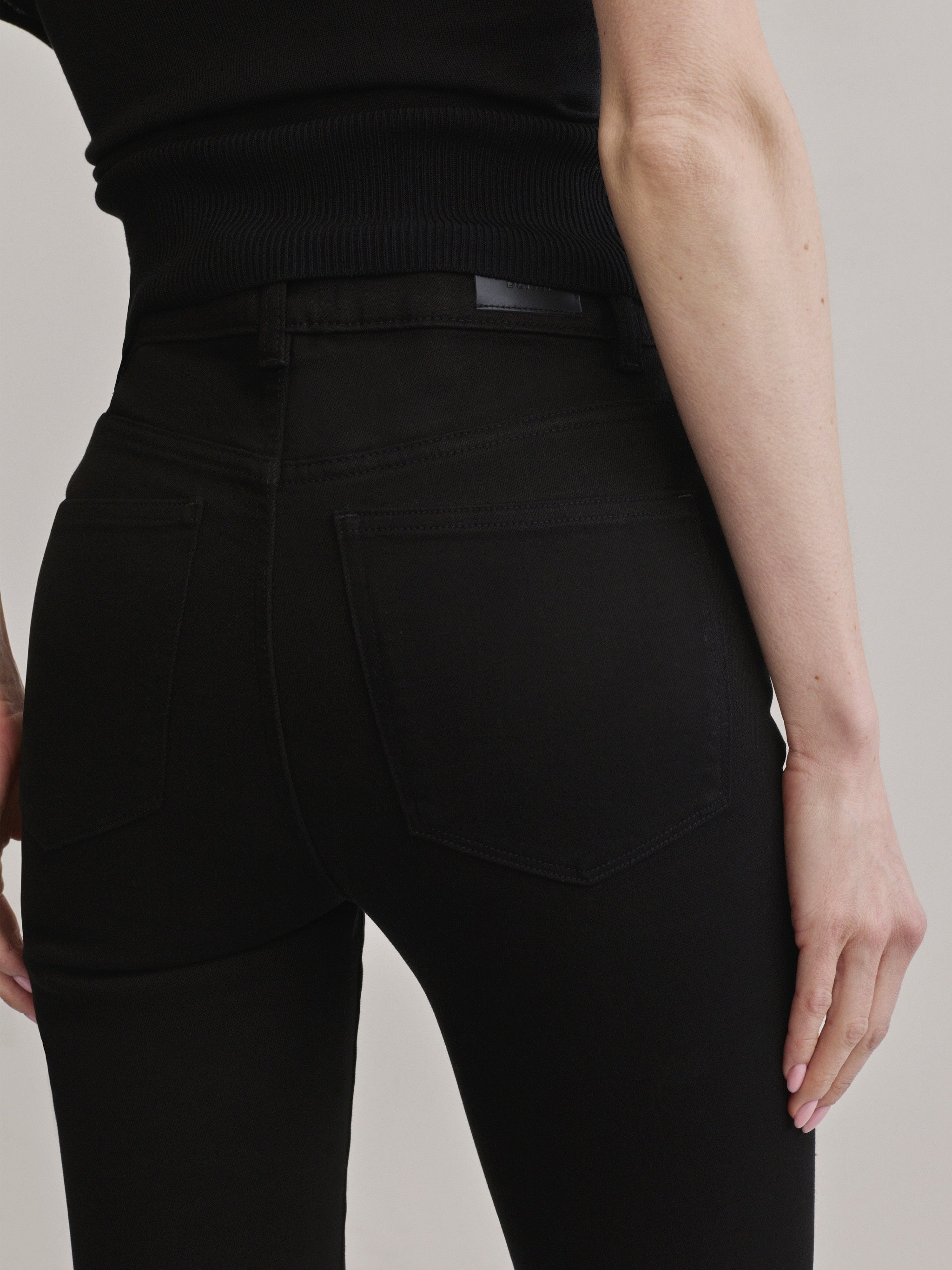 DL1961 Bridget Bootcut Instasculpt jeans in black 'Black Pintuck', back pocket and DL1961 patch detail.