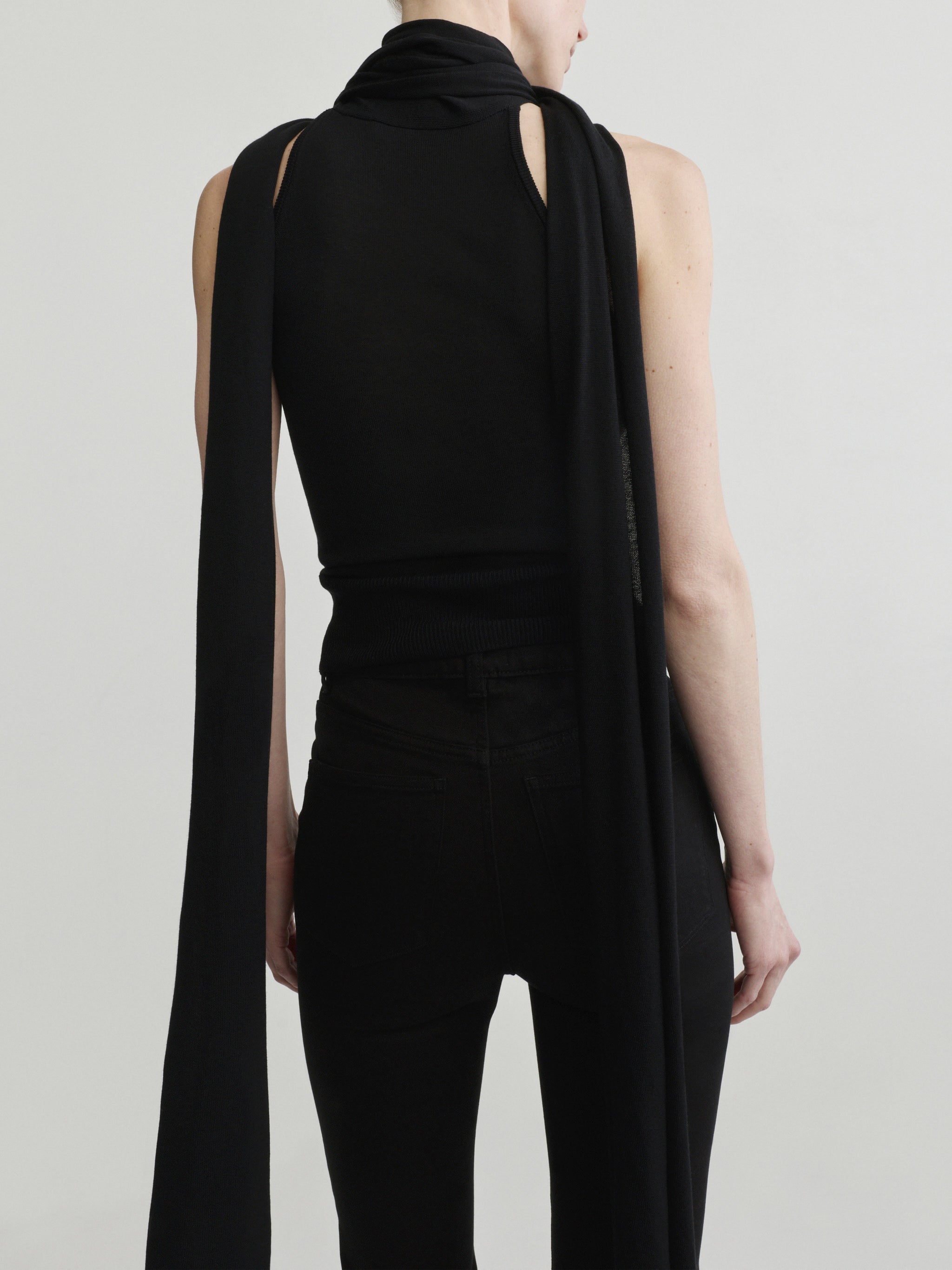 Bridget Boot jeans in Black Pintuck with Black Scarf Tie Top, model back view, upper-body crop.